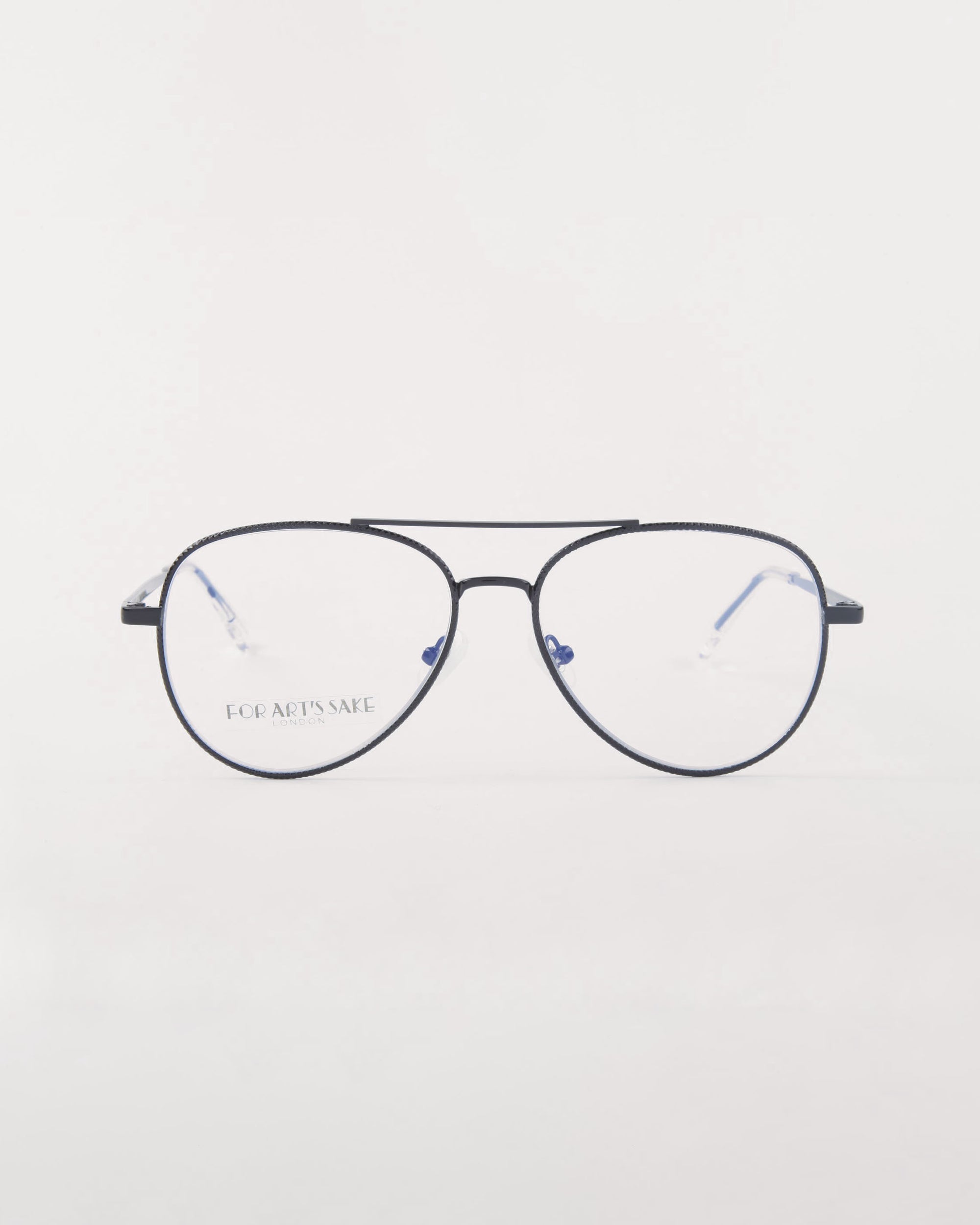 A pair of Cleo optical glasses from For Art's Sake® featuring thin, black-rimmed aviator-style frames with clear prescription lenses is centered against a plain white background. The temples and nose pads are visible, and text on the lower left lens reads "FOR ART'S SAKE®.