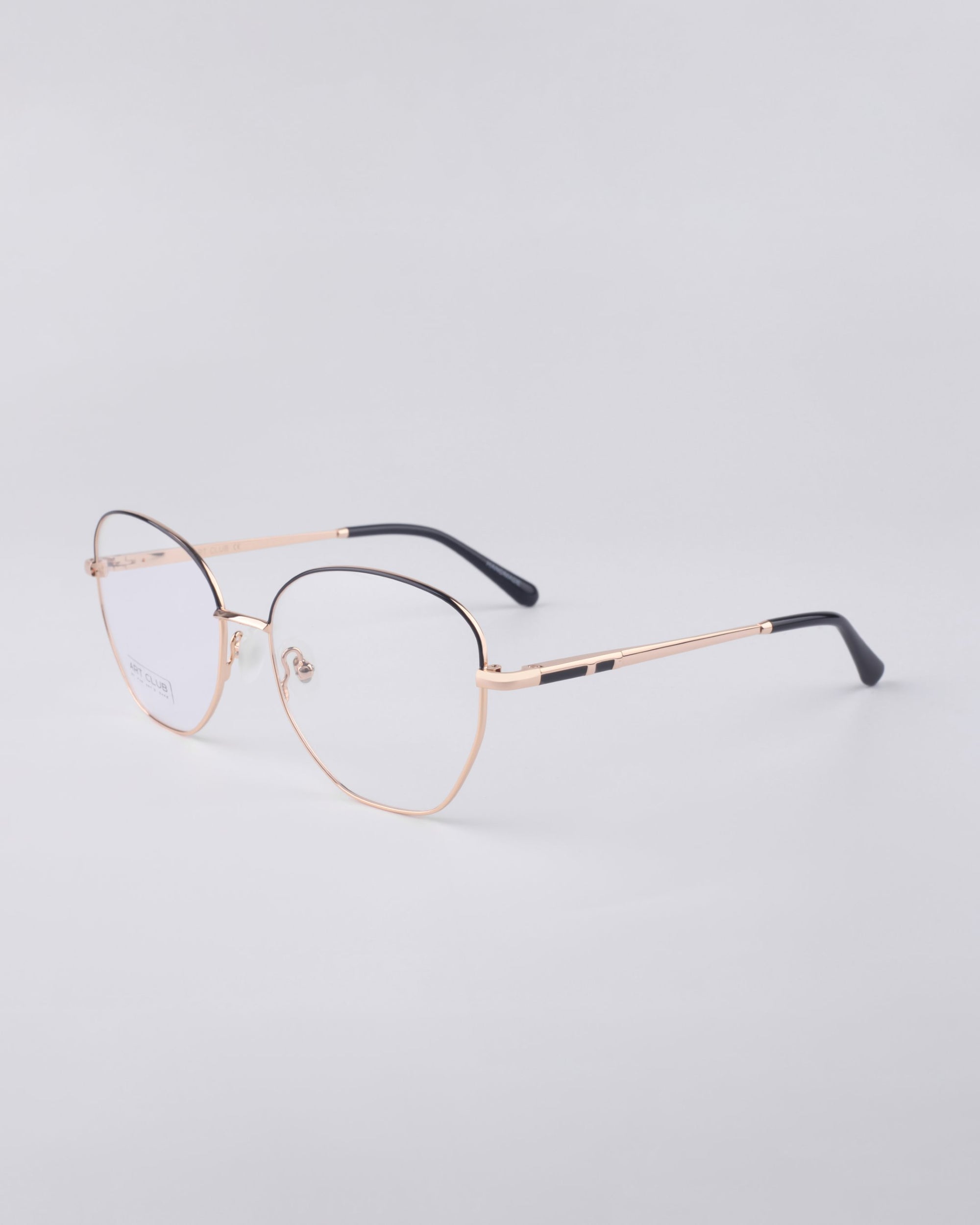 For Art's Sake® Coco gold metal eyeglasses feature round blue light filter lenses and slim black temple tips, elegantly displayed on a light grey background.
