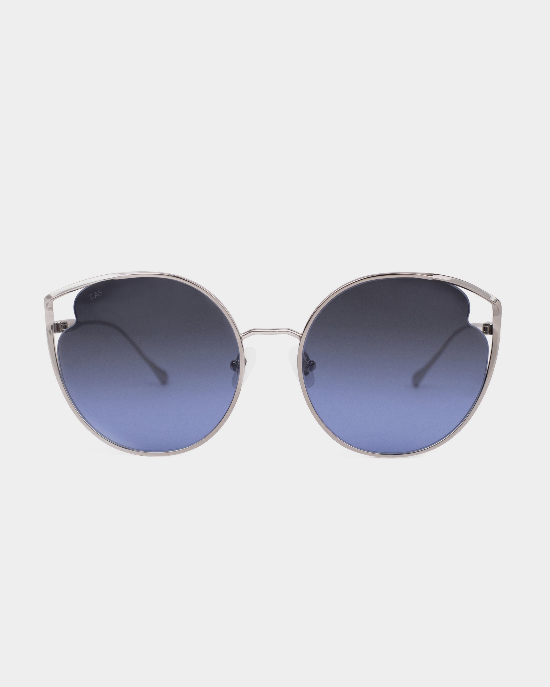 A pair of stylish sunglasses, the Cat by For Art's Sake®, featuring large, round, blue-tinted nylon lenses and a thin metallic frame. The frame has a minimalist design with slight outward flaring at the temples and adjustable nosepads for added comfort. The background is plain and white.