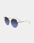 Introducing "Cat" sunglasses from For Art's Sake®—a stunning pair of round sunglasses featuring sleek, slim silver metal frames and dark blue gradient nylon lenses. The design includes a slight curve over the top of each lens, adding a unique touch to the classic style. These stylish sunglasses offer UVA & UVB protection and come with adjustable nose pads for added comfort.