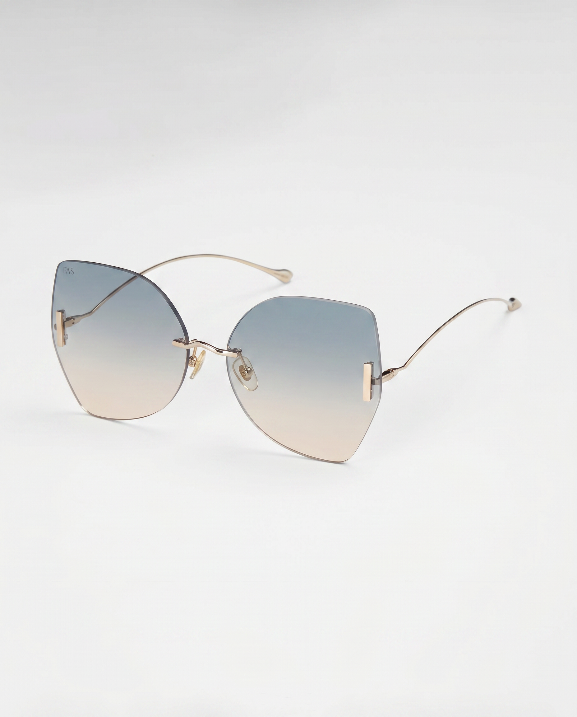 For Art's Sake® Starlight sunglasses feature gradient blue-to-clear lenses, slim gold arms, UV protection, and a chic rimless design, displayed on a white background.