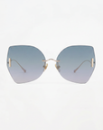 The Starlight sunglasses by For Art's Sake® feature large, frameless butterfly-shaped blue gradient lenses, thin gold temples, and gold nose pads with UV protection, displayed on a plain white background.