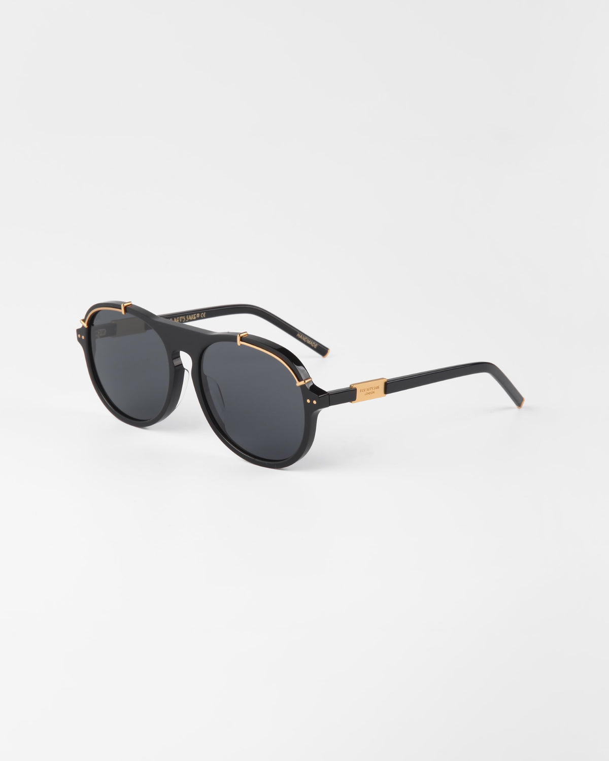 A pair of black General sunglasses with dark nylon lenses and 18-karat gold plated accents on the hinges and bridge. The temples are black with a gold detail near the hinges, and the For Art's Sake® brand name is visible on the side. The background is plain white.