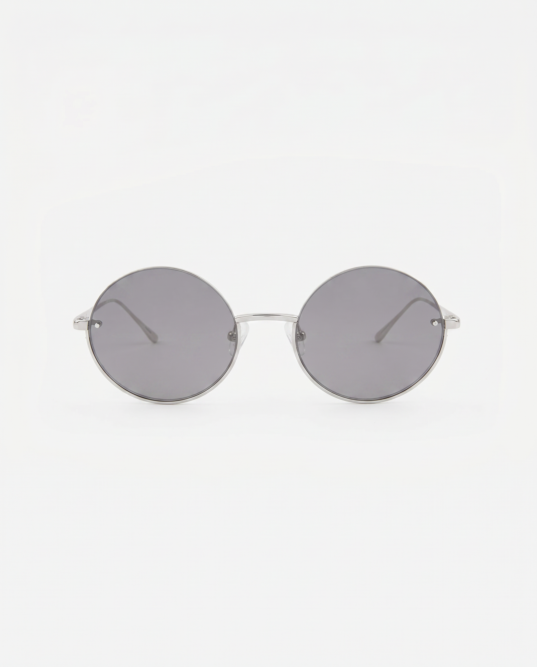 Skyline-Grey round sunglasses by For Art's Sake® feature thin metal frames and dark lenses, shown on a white background—ideal to pair with minimalist earrings for a sleek, modern vibe.
