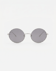 Skyline-Grey round sunglasses by For Art's Sake® feature thin metal frames and dark lenses, shown on a white background—ideal to pair with minimalist earrings for a sleek, modern vibe.