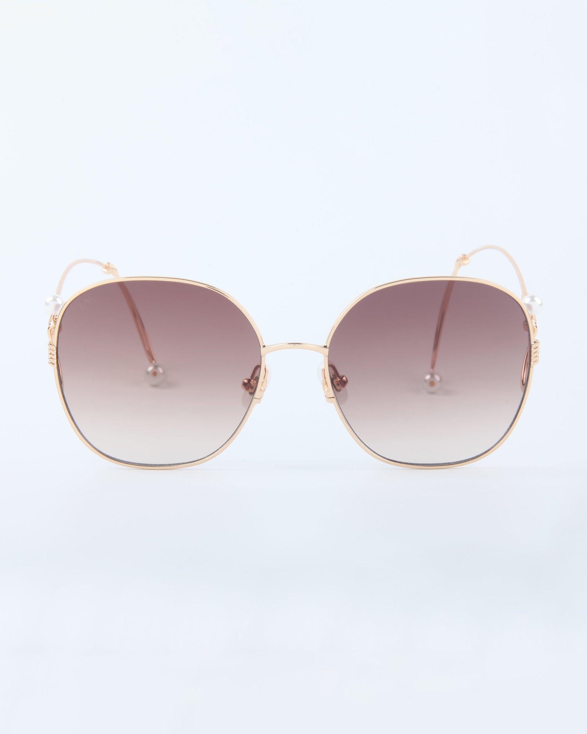 The Lemonade sunglasses by For Art's Sake® feature oversized gold wire frames and gradient brown-tinted lenses for a bold, stylish look, shown against a plain white background.