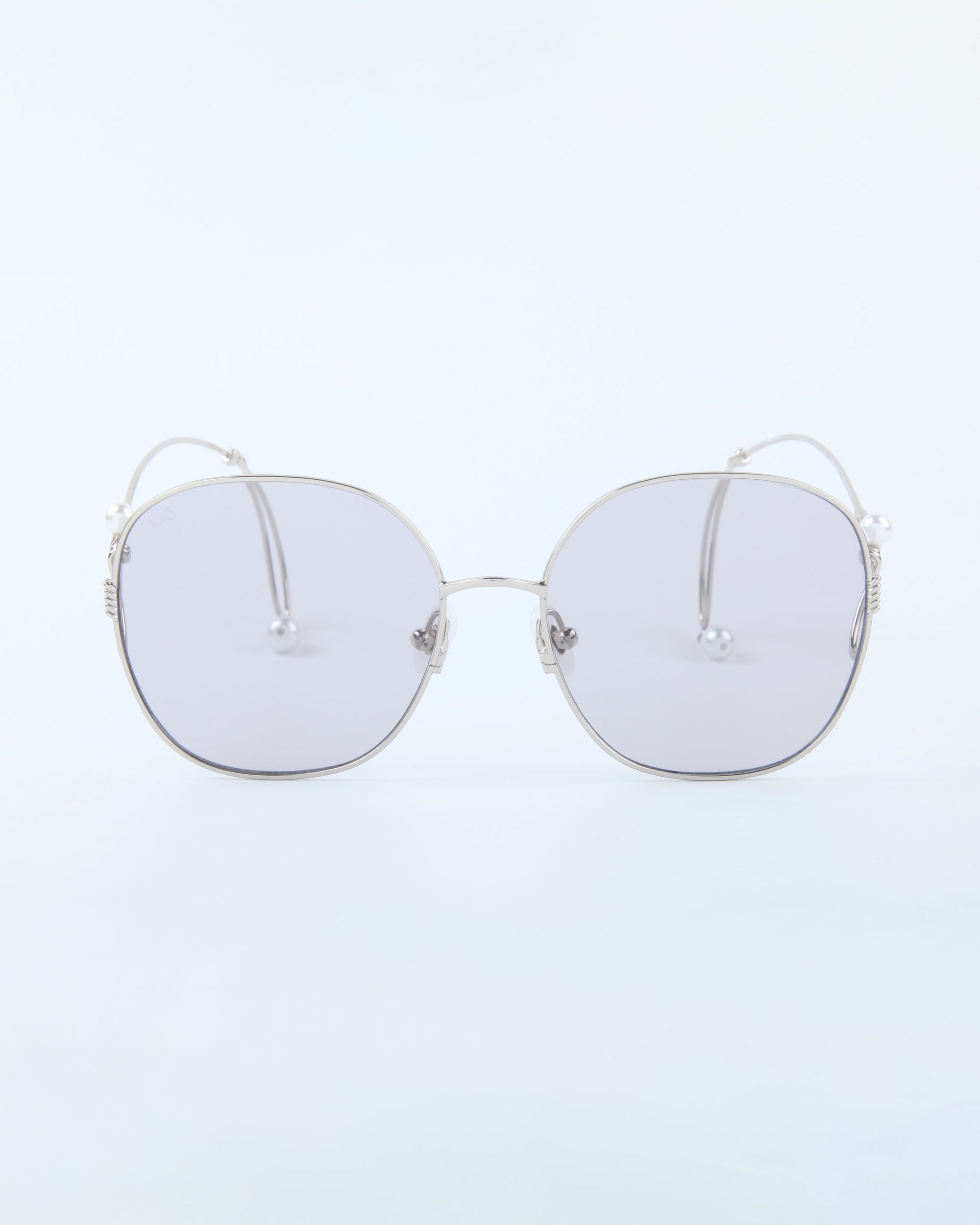 The Lemonade sunglasses by For Art's Sake® feature silver metal frames and oversized rounded gray lenses, making a bold statement, shown against a clean, light background.