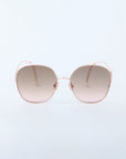 Front view of the last piece Lemonade sunglasses by For Art’s Sake®, featuring stylish oversized rose gold metal frames, embellished with faux-pearl detailing and gradient brown lenses, set against a plain light background.