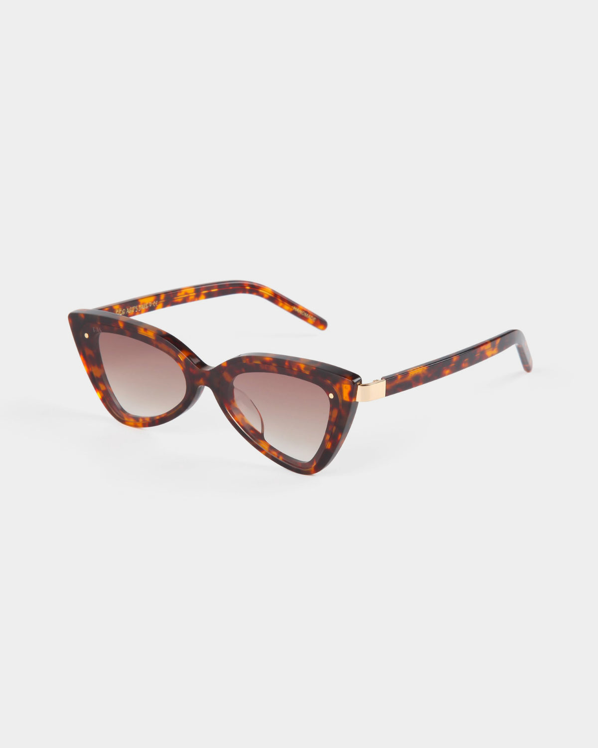 Introducing the Mad Mad sunglasses by For Art's Sake®: a pair of stylish cat-eye sunglasses featuring UVB-protected tortoiseshell acetate frames and brown gradient lenses. The sleek arms are also tortoiseshell and adorned with a small gold accent on each side. The sunglasses are elegantly presented against a plain white background.