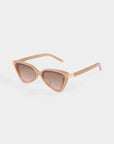 A pair of stylish For Art's Sake® Mad Mad cat-eye sunglasses with light brown acetate frames and brown-tinted lenses. The frame is slightly angular with rounded corners at the lens edges and smoothly curving temples. The background is white.