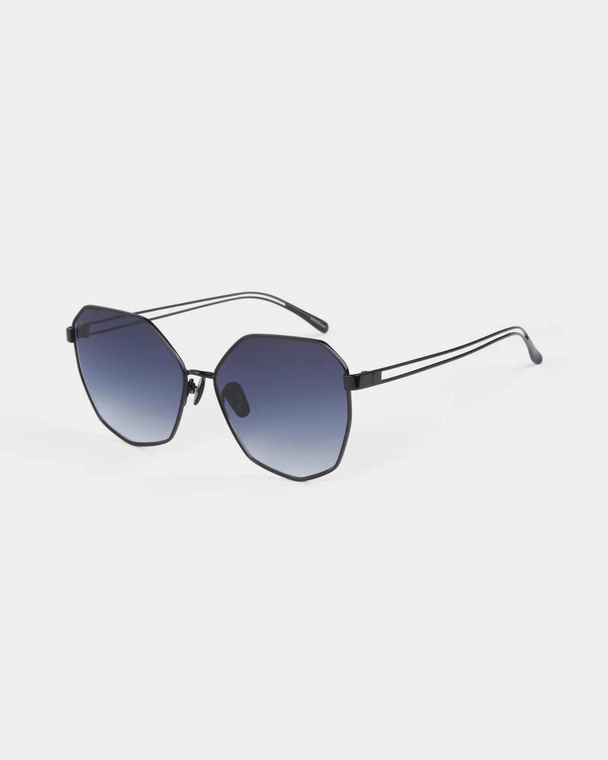 A pair of stylish For Art's Sake® Moma shades featuring dark, gradient lenses and a thin black frame. The design has a modern, geometric shape with slightly angled edges and slim arms, giving them a sleek and contemporary look. These sunglasses offer 100% UVA and UVB protection against harmful rays. The background is plain white.