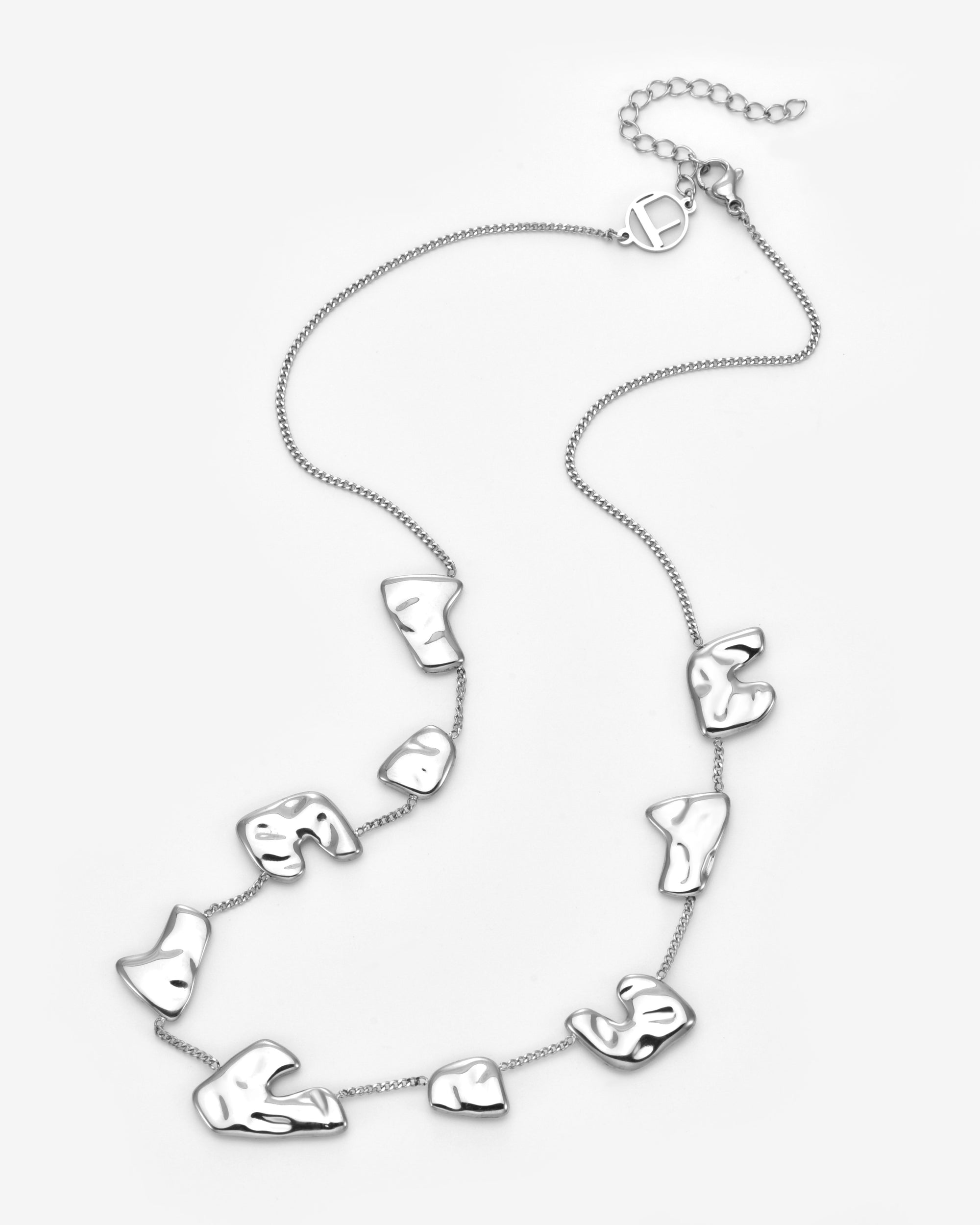 The Forms Necklace by For Art's Sake® showcases abstract, irregular metal shapes spaced along a fine chain with an adjustable clasp, presented on a plain white background.