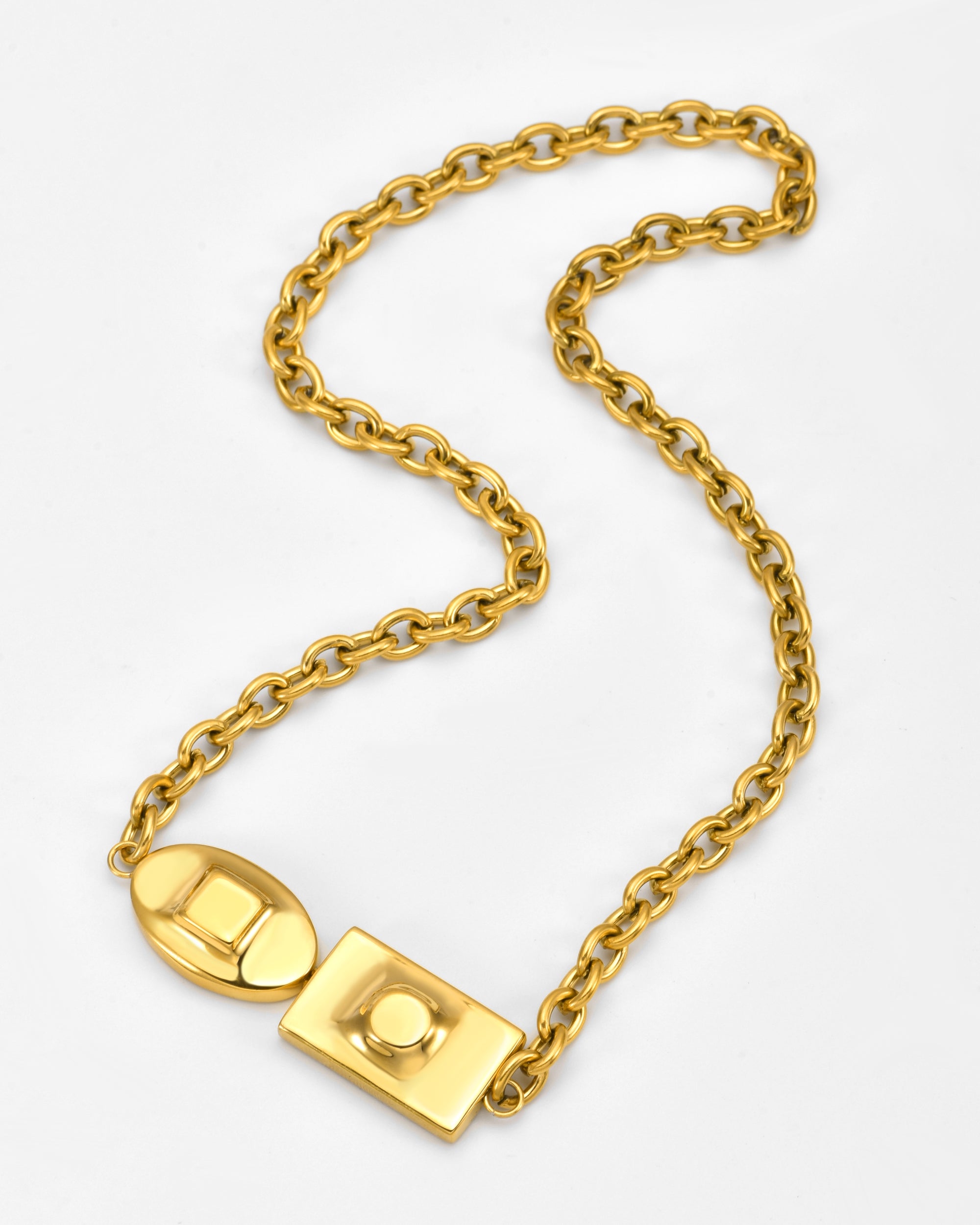 The Geometry Necklace by For Art's Sake® features large, rounded gold chain links and an oversized rectangular and oval clasp, shown on a plain white background.
