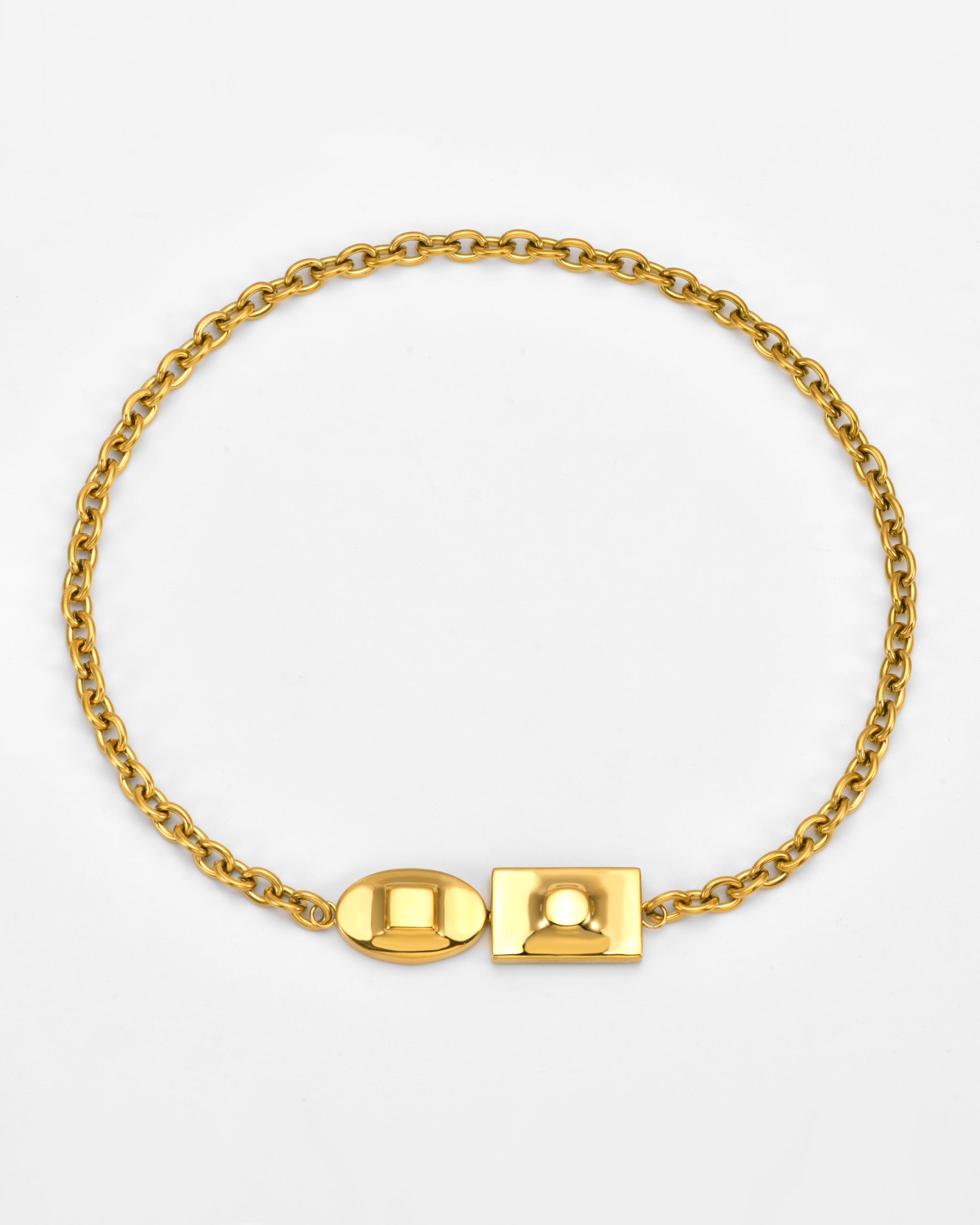 The Geometry Necklace by For Art's Sake® is a gold chain with oval and rectangular clasps, displayed in a circle on a white background.