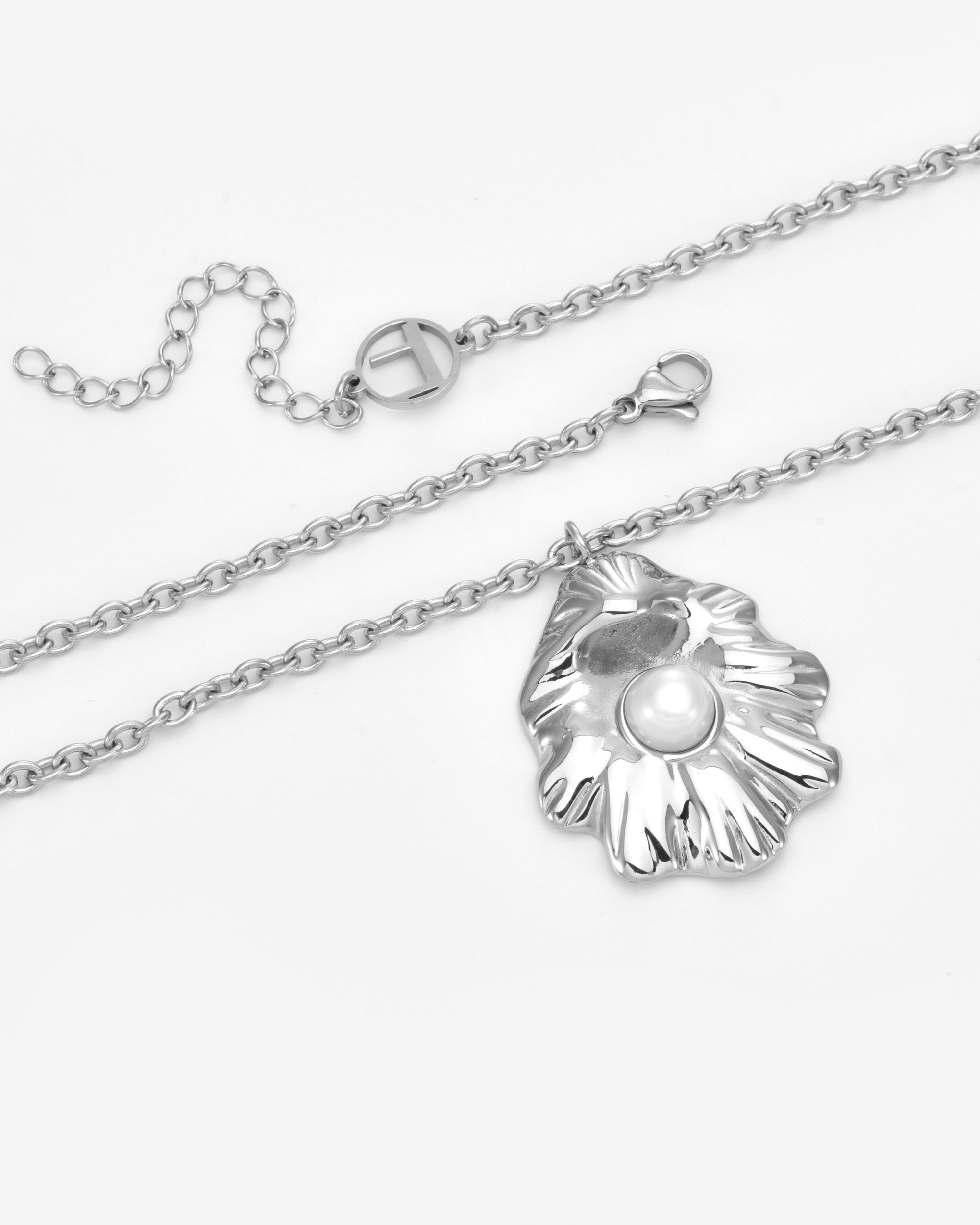 The Shell Pendant by For Art's Sake® is a silver chain necklace featuring an abstract oyster shell with a single white freshwater pearl, finished with a lobster clasp and a cut-out circular charm.