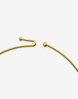 Close-up of The Rose Choker by For Art's Sake® on a white background, highlighting its delicate gold design with a small ball at one end and a curved hook at the other.