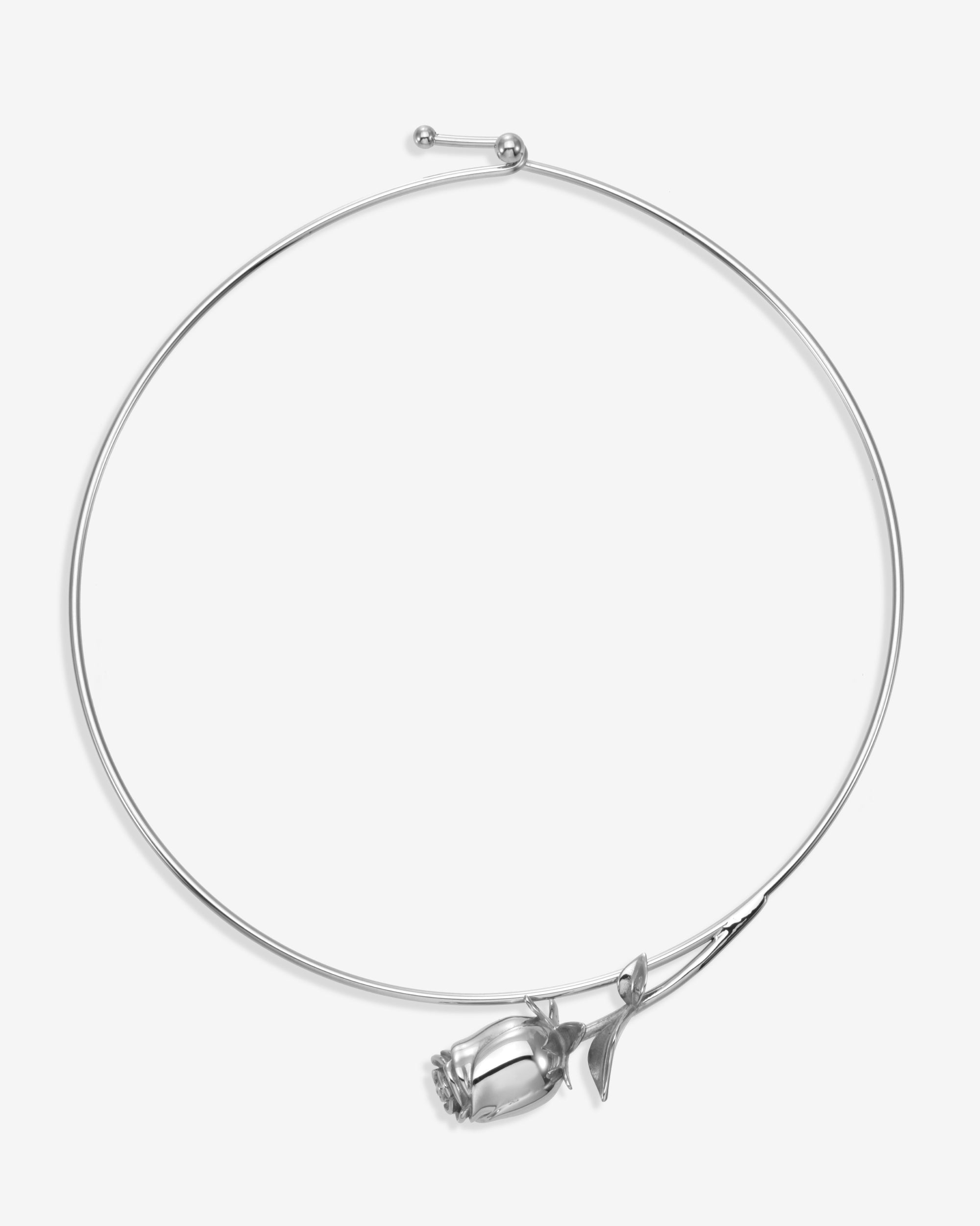 The Rose Choker by For Art's Sake® is a minimalist silver necklace with a sculpted rosebud and leaf pendant, capturing modern elegance in jewelry.