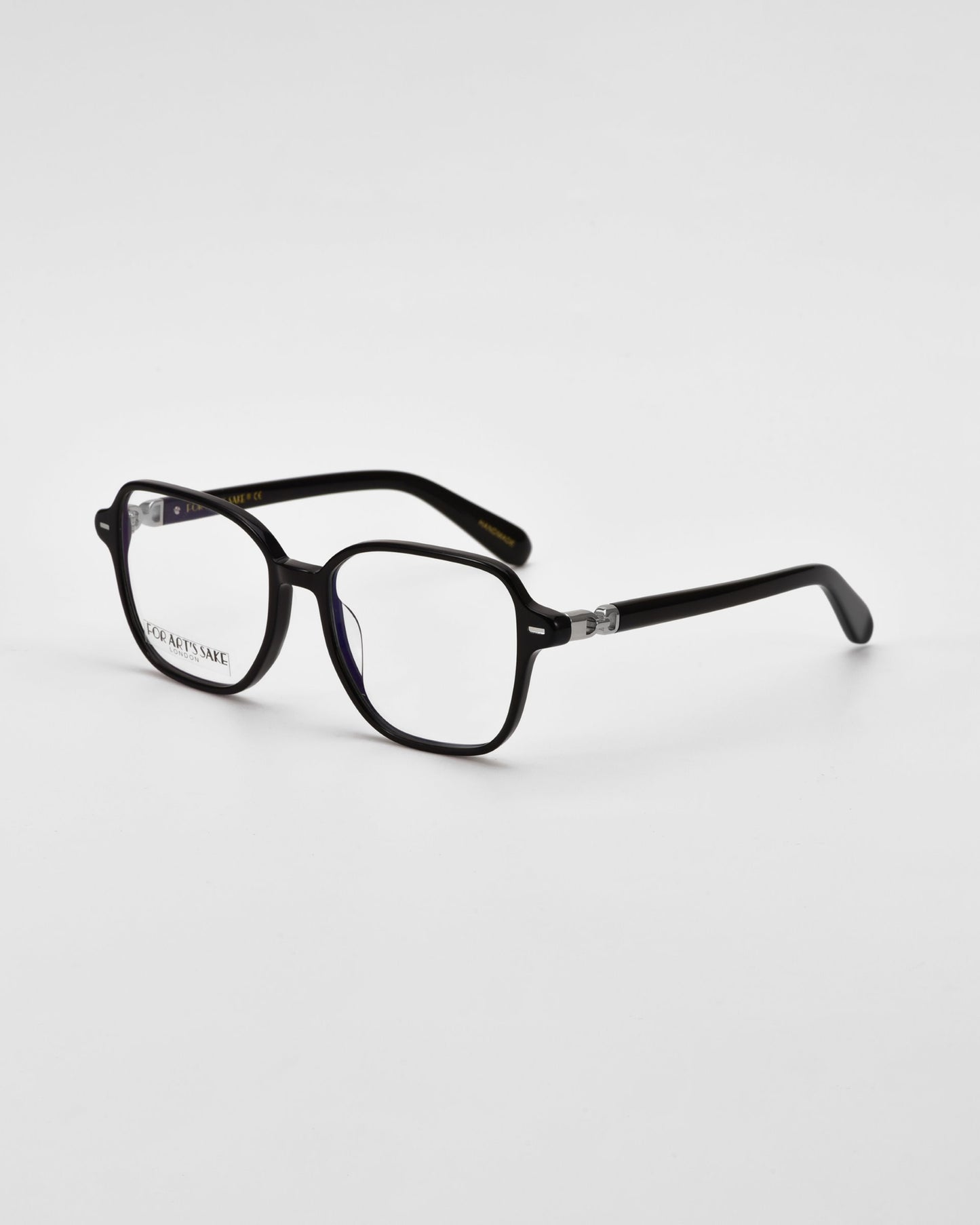 Black cat-eye framed optical glasses on a white background facing sidewards.