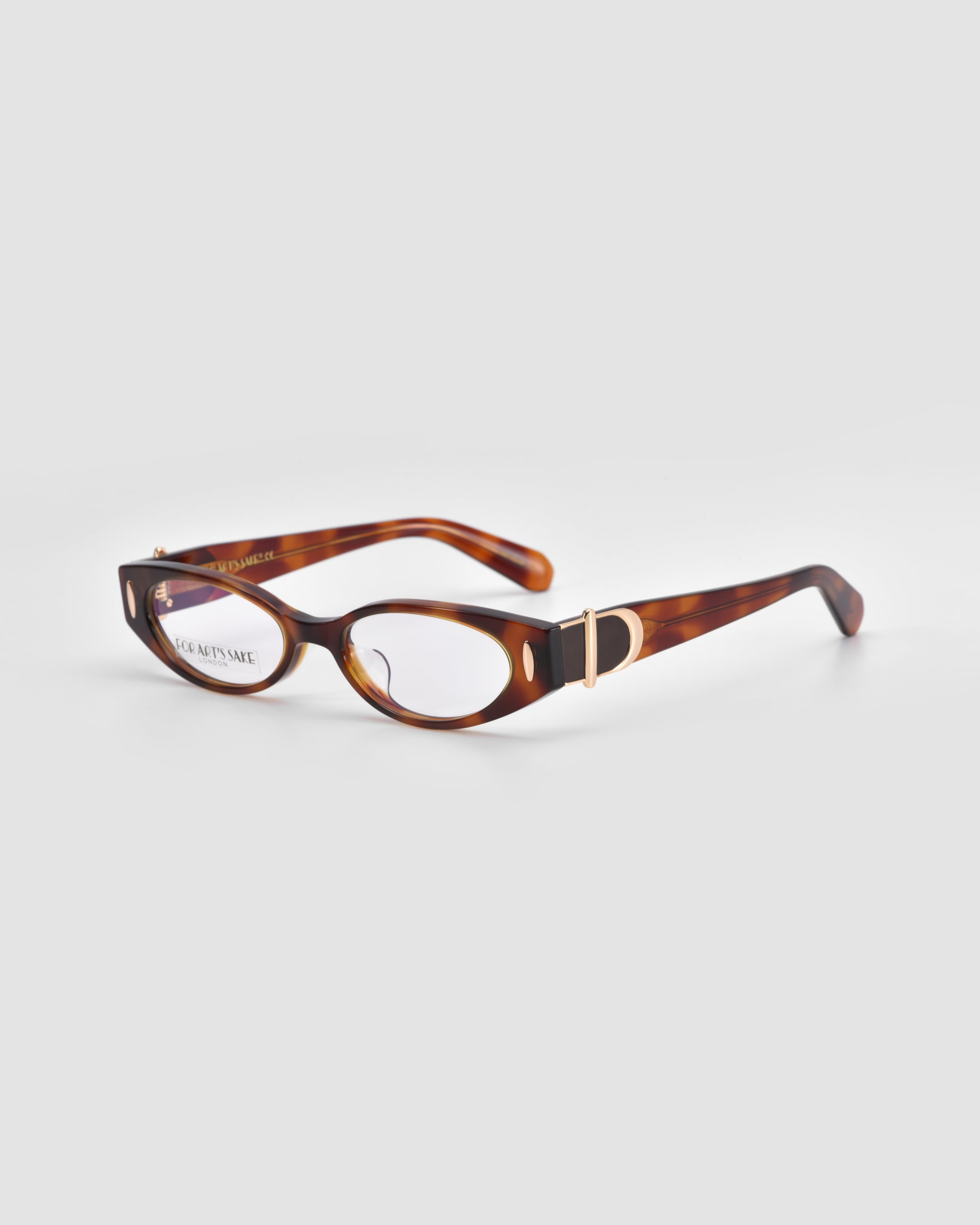 For Art's Sake® Cigar: Thick vintage tortoiseshell oval optical frames with gold “D” detail on the temples, shown on a light gray background.