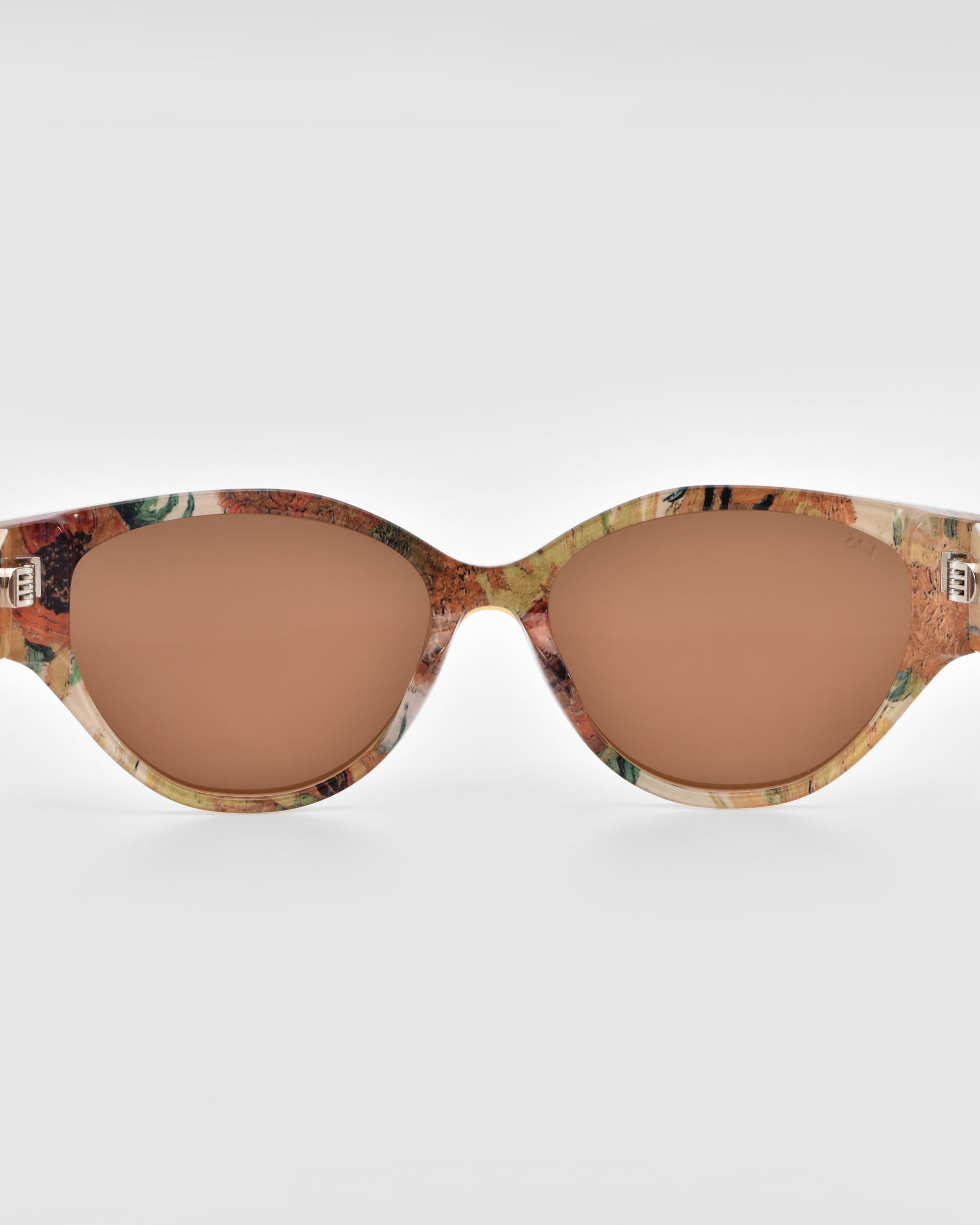 The For Art&#39;s Sake® Vincent Van Gogh cat-eye sunglasses feature warm brown-tinted lenses and a marbled frame in beige, brown, and green—perfect for unique collectible eyewear, shown on a plain white background.