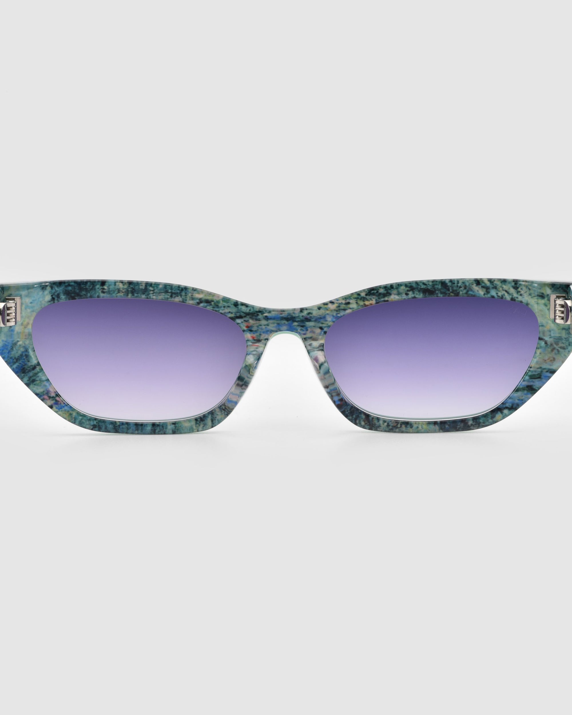 Front view of For Art&#39;s Sake® Claude Monet (Limited Edition) cat-eye sunglasses with blue-green marbled frames and purple gradient lenses, set against a plain light gray background.