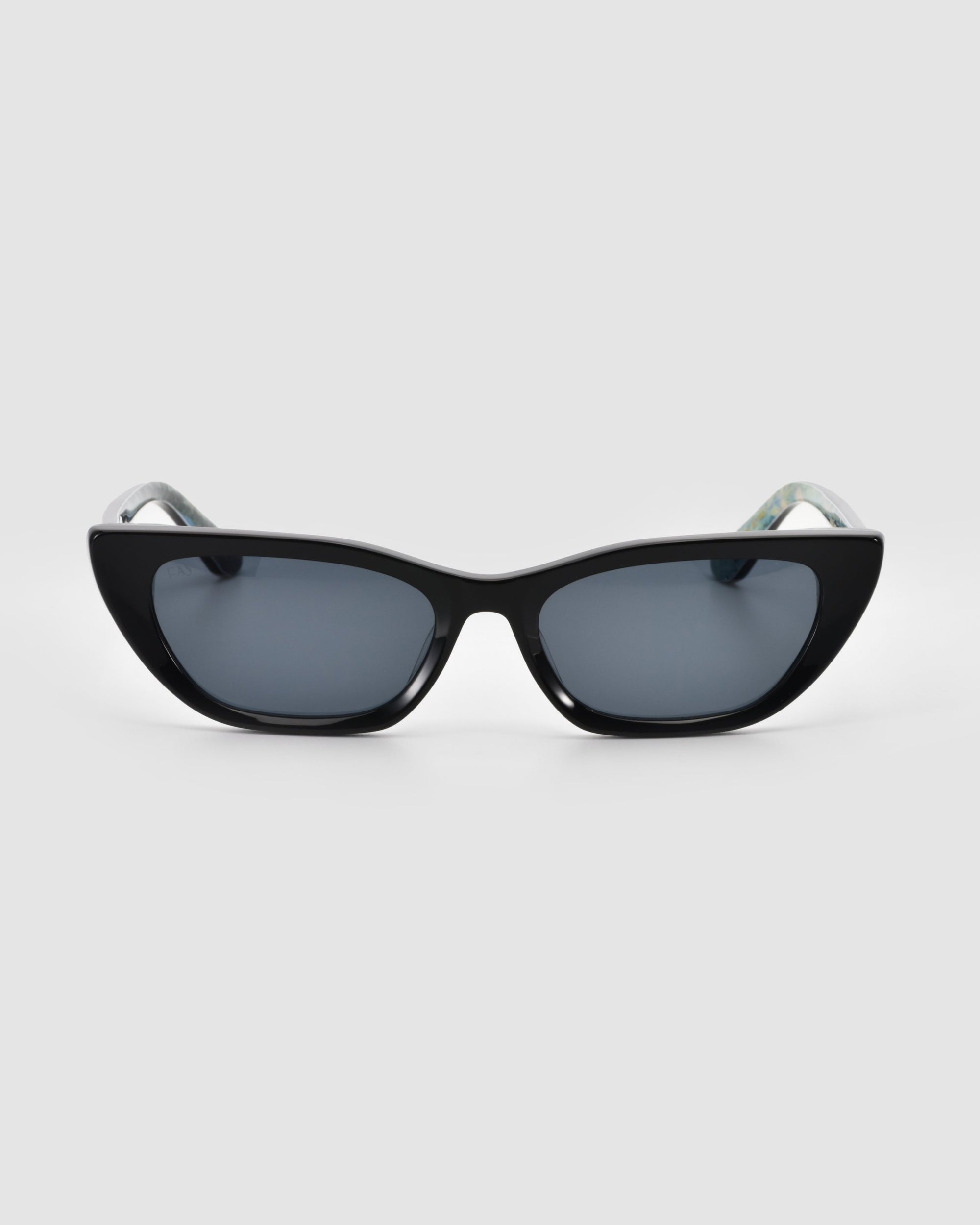 The Claude Monet limited edition cat-eye sunglasses by For Art's Sake® feature a black frame and dark tinted lenses, displayed from the front against a plain light gray background.