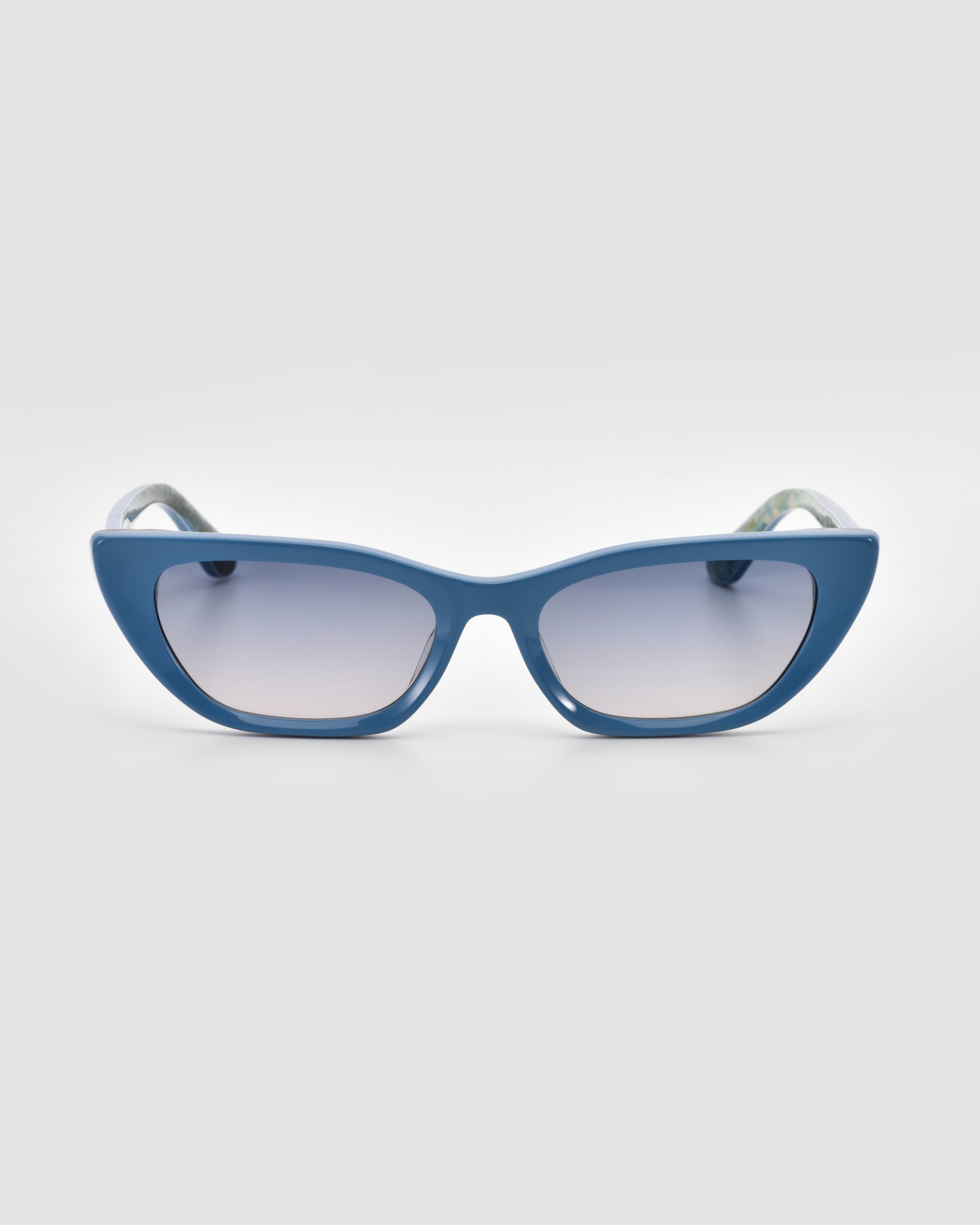 The Claude Monet sunglasses by For Art's Sake® feature blue cat-eye frames and reflective lenses, displayed front-facing on a light gray backdrop—a chic limited edition accessory ideal for bold style statements.