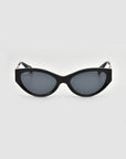 For Art's Sake® Unfold sunglasses: black cat-eye frames with dark tinted lenses and a sculptural silhouette, shown front-facing against a plain light gray background.