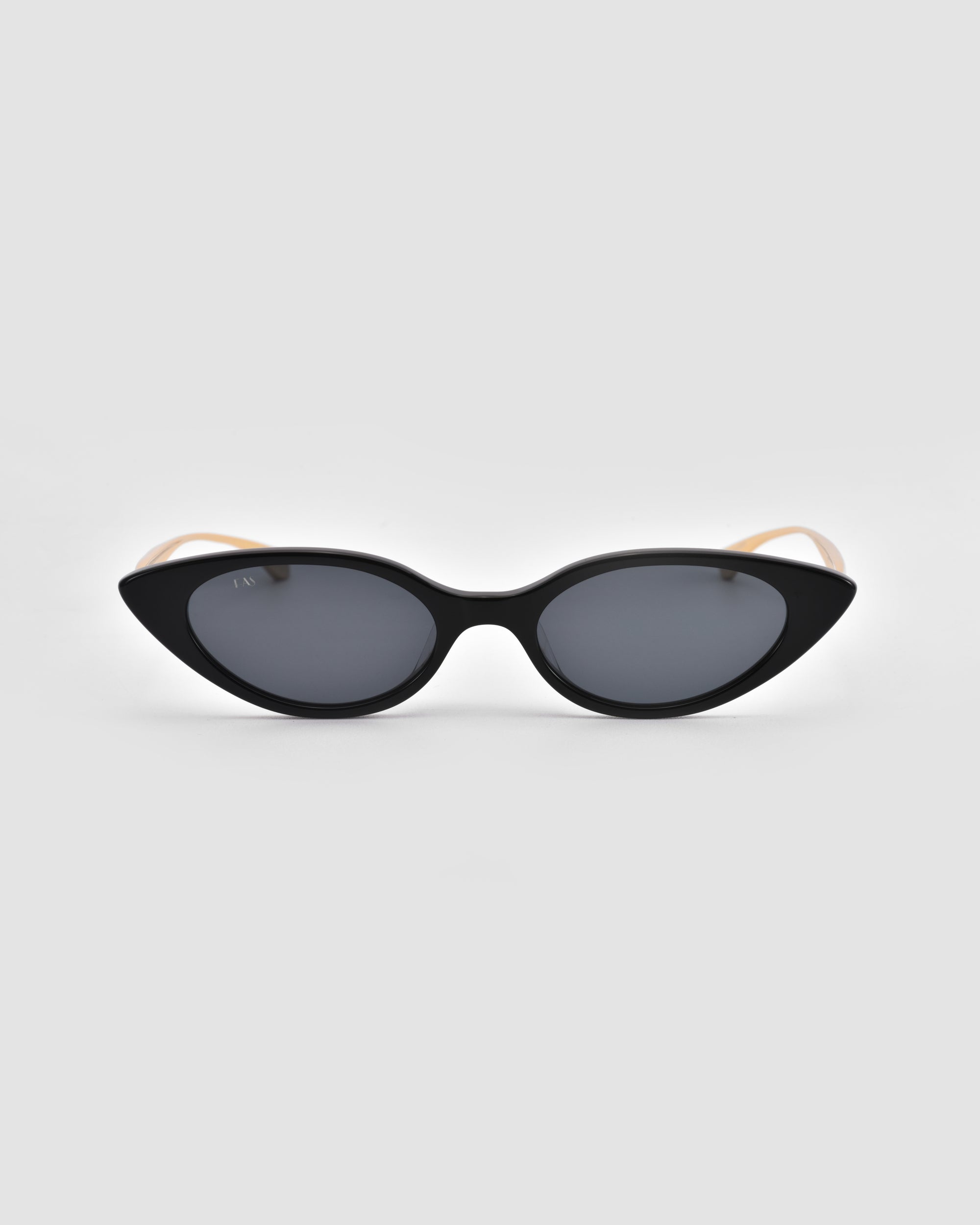 The For Art's Sake® Slash sunglasses feature black sculptural cat-eye frames with dark lenses and beige arms, shown against a plain light gray background.