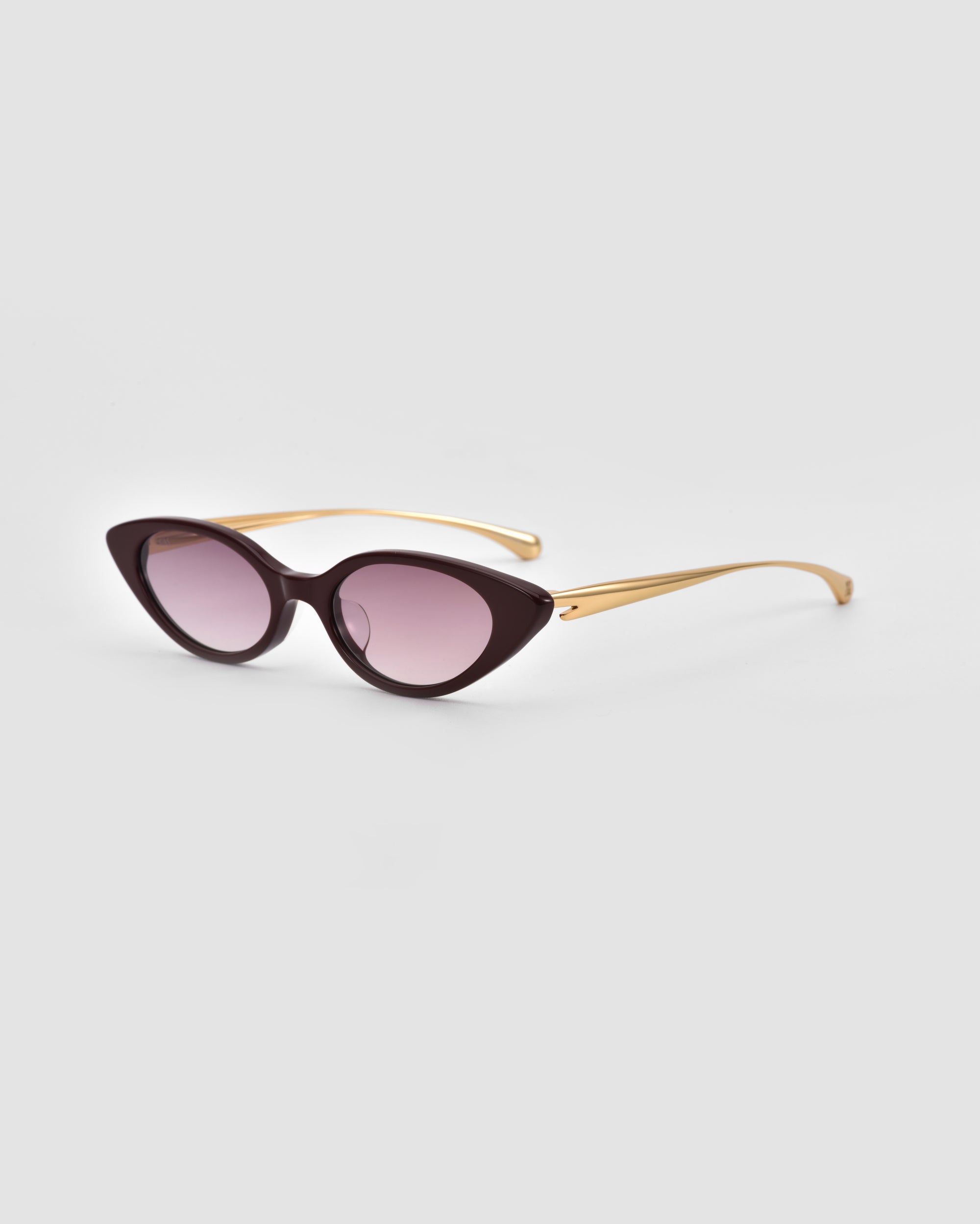 For Art's Sake® Slash sunglasses feature sculptural cat-eye black frames, gradient purple lenses, and gold-toned temples, shown on a light grey background—a stylish choice for contemporary eyewear lovers.
