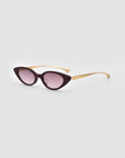 For Art's Sake® Slash sunglasses feature sculptural cat-eye black frames, gradient purple lenses, and gold-toned temples, shown on a light grey background—a stylish choice for contemporary eyewear lovers.