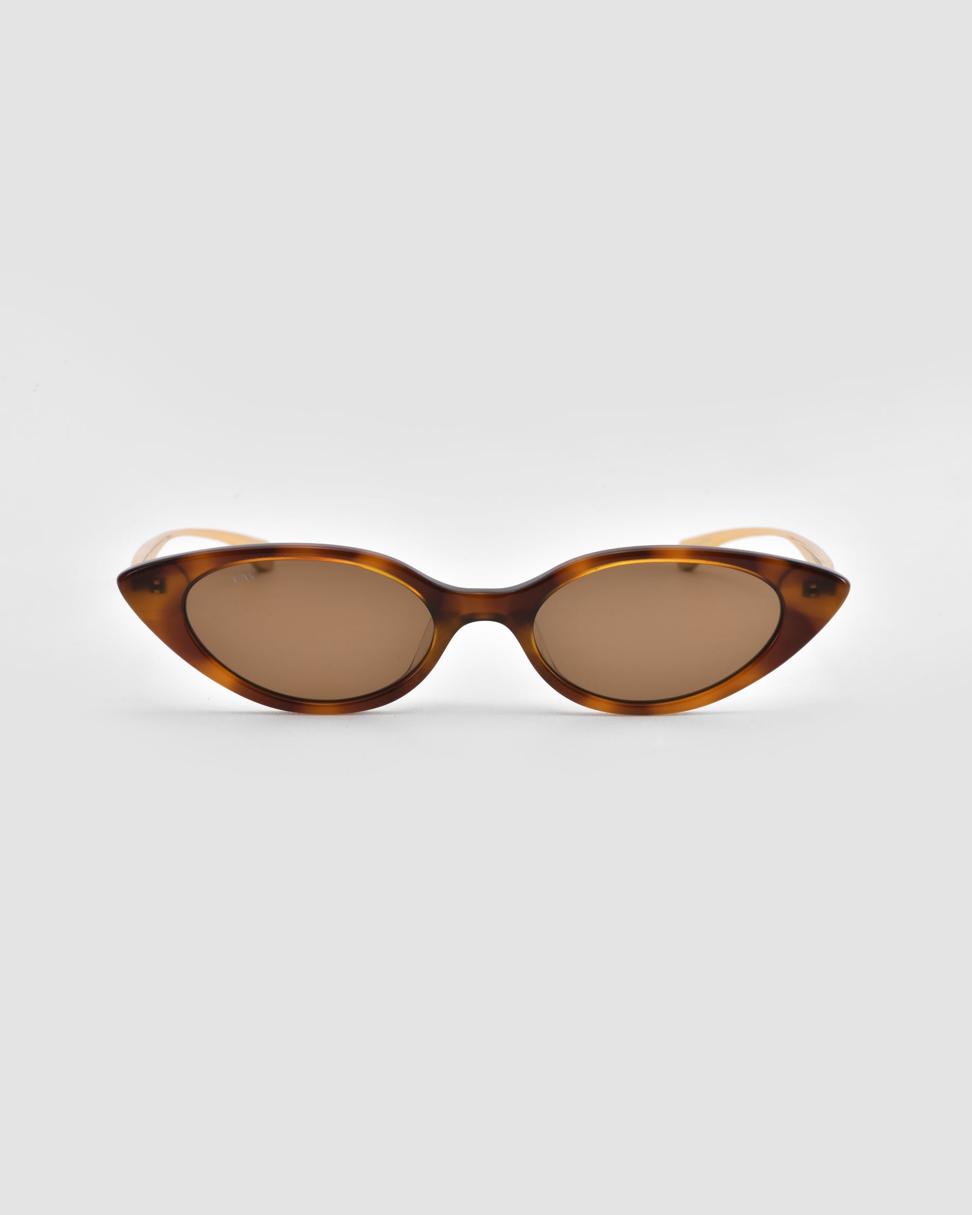 For Art's Sake® Slash cat-eye sunglasses feature a brown tortoiseshell frame and brown-tinted lenses, embodying modern style and shown against a light gray background.