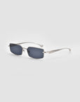 For Art's Sake® Lucio sunglasses feature rectangular silver metal frames with dark tinted lenses, thin slightly curved temples, and a unique 3D swoosh design, displayed on a light gray background.