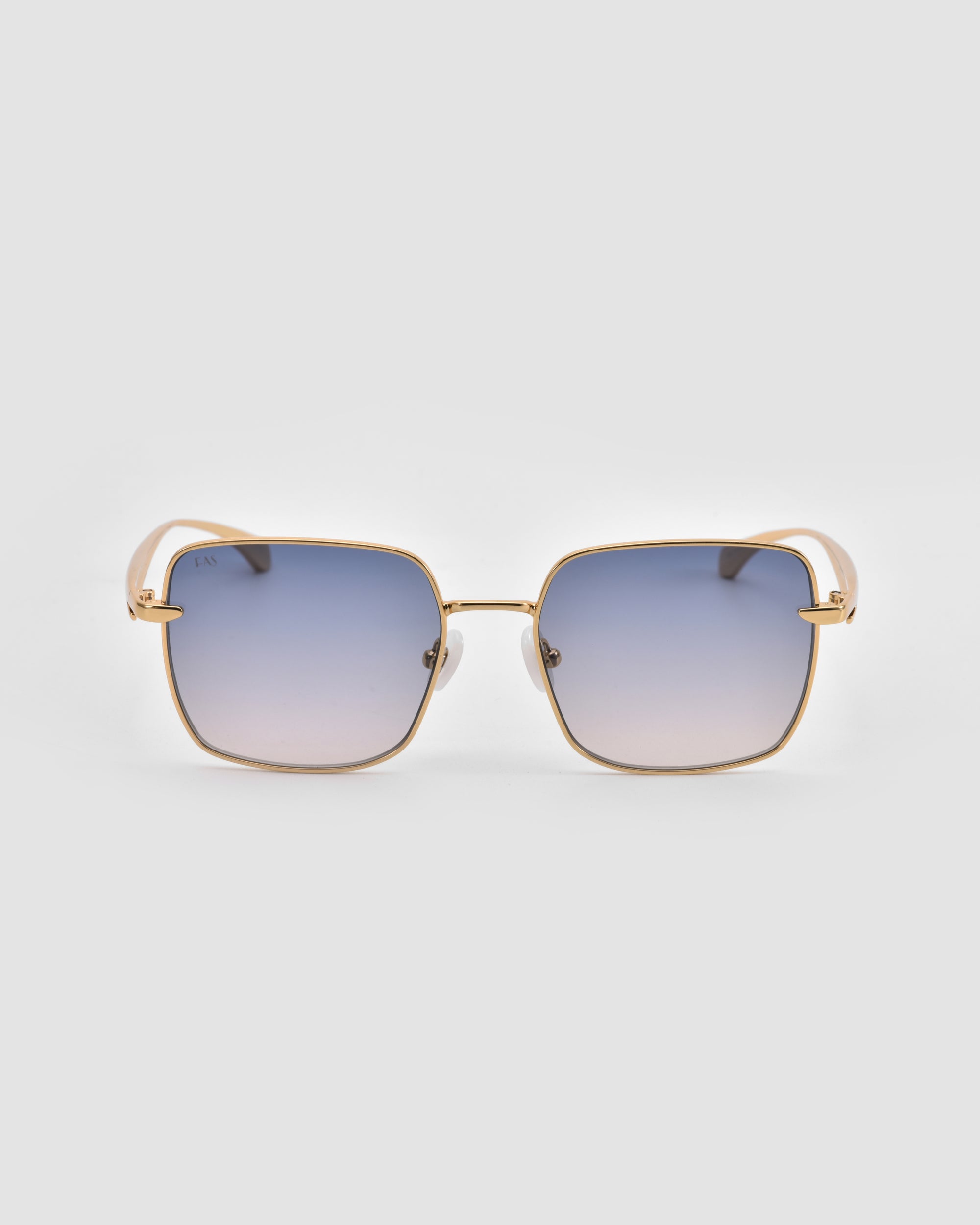 The For Art's Sake® Edge sunglasses feature gold rims, a rectangular shape, blue gradient lenses, and sculpted white temple tips, shown against a plain light gray background.