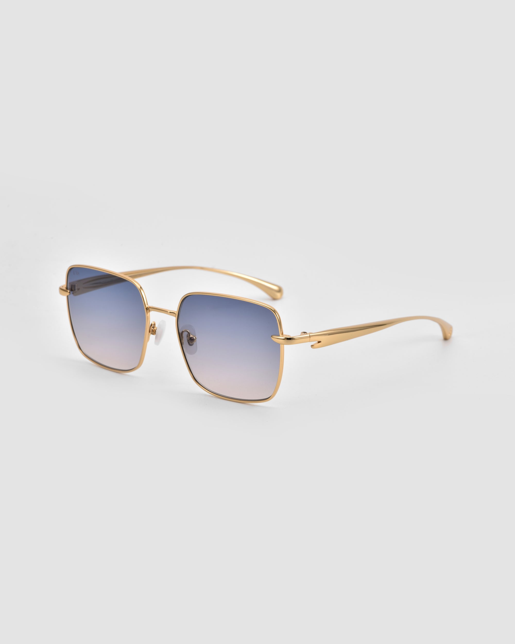 For Art’s Sake® Edge sunglasses feature a refined square silhouette with gold metal frames and blue gradient lenses, shown on a light gray background.