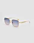 For Art’s Sake® Edge sunglasses feature a refined square silhouette with gold metal frames and blue gradient lenses, shown on a light gray background.