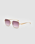 The For Art’s Sake® Edge sunglasses feature gold frames, a rectangular shape, and square purple gradient lenses with sculptural details, shown against a plain light gray background.