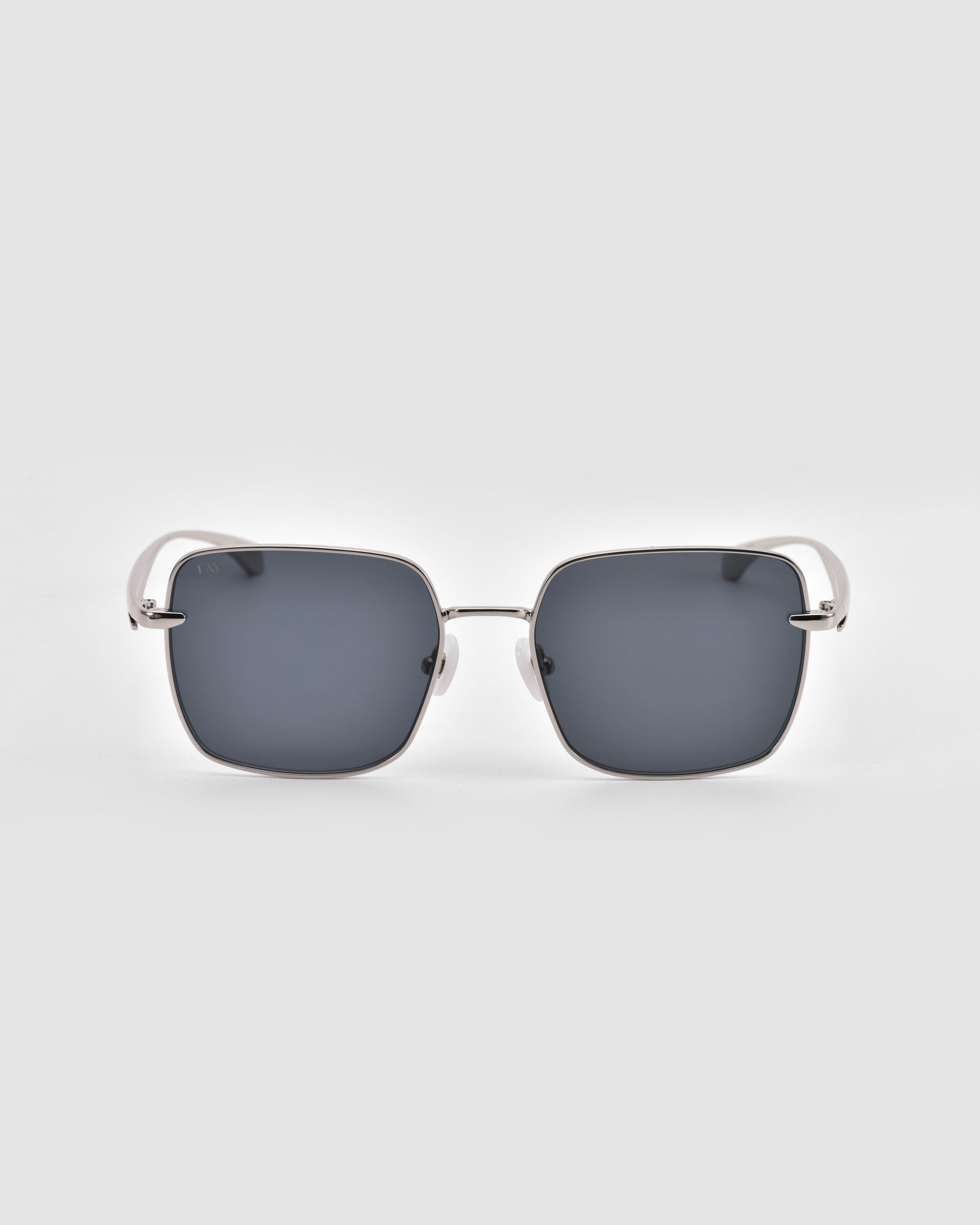 The For Art's Sake® Edge sunglasses feature a rectangular silhouette, dark lenses, thin silver metal frames, and curved white arms, shown against a plain light gray background.