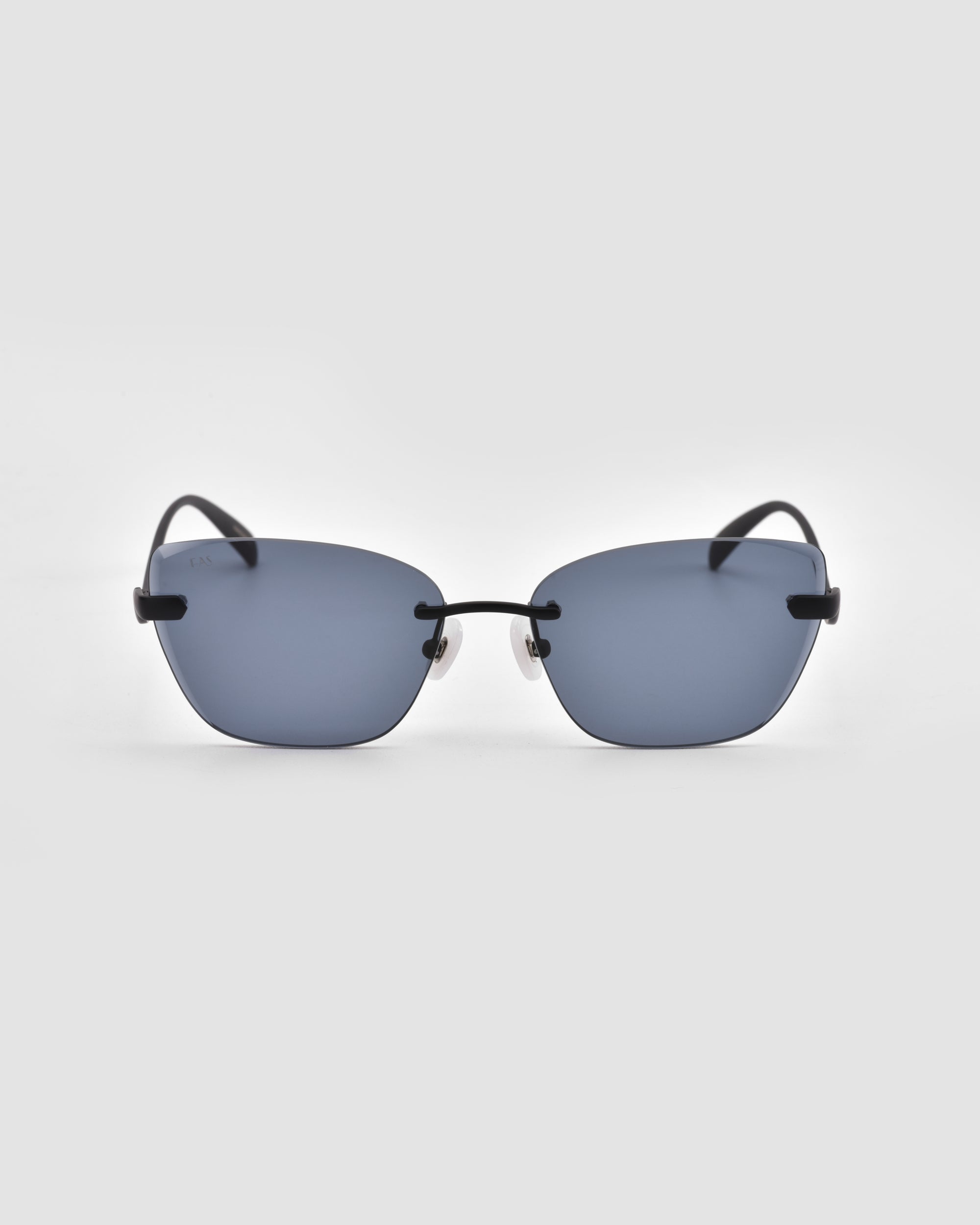 The Spark sunglasses by For Art's Sake® feature rimless rectangular dark blue lenses and thin black temples, shown against a plain light gray background.
