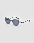 The For Art's Sake® Spark sunglasses feature rectangular blue-tinted lenses and slim black arms, shown against a light gray background.