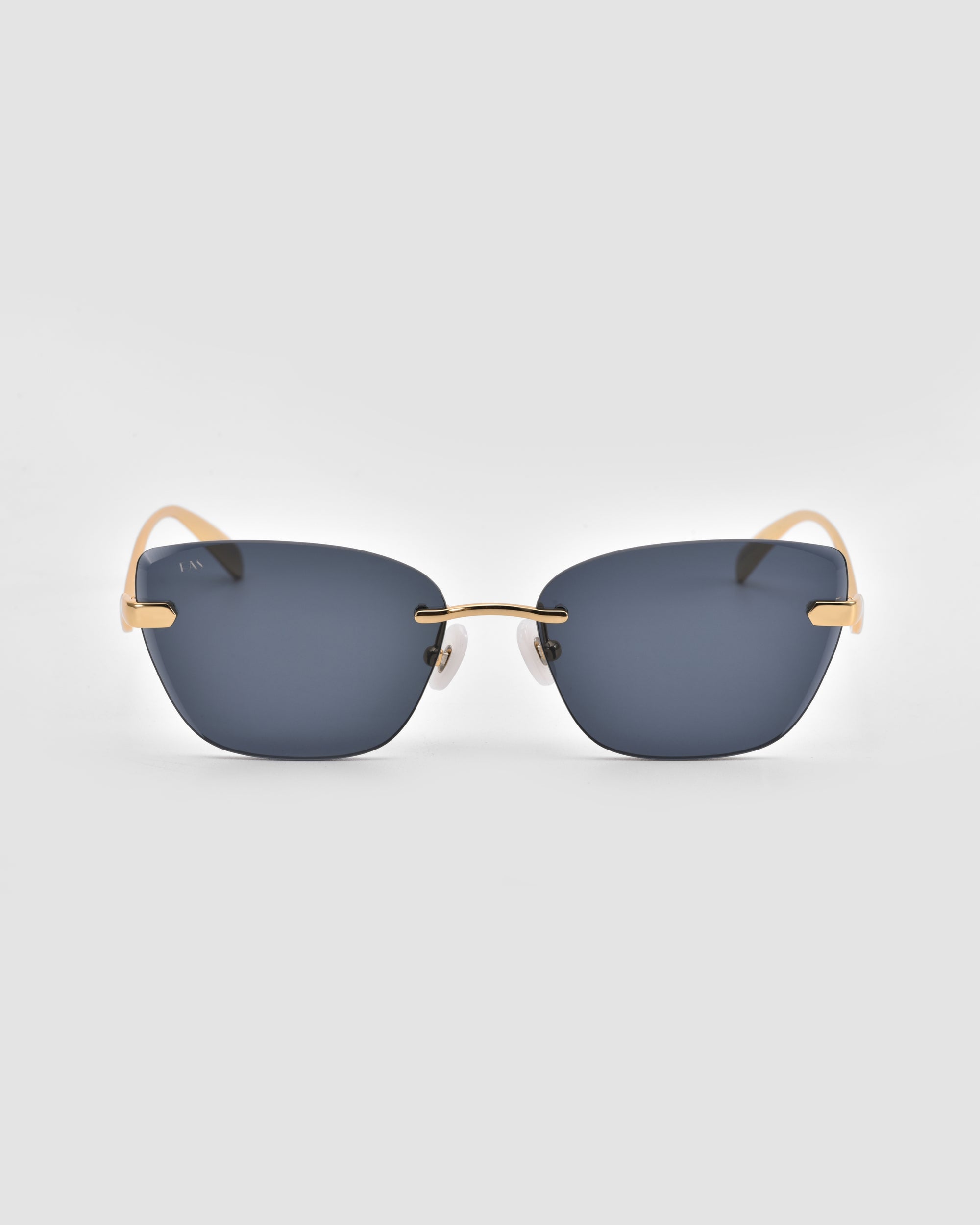 For Art's Sake® Spark sunglasses feature dark gray rectangular rimless lenses and slim gold arms, shown on a plain light gray background.