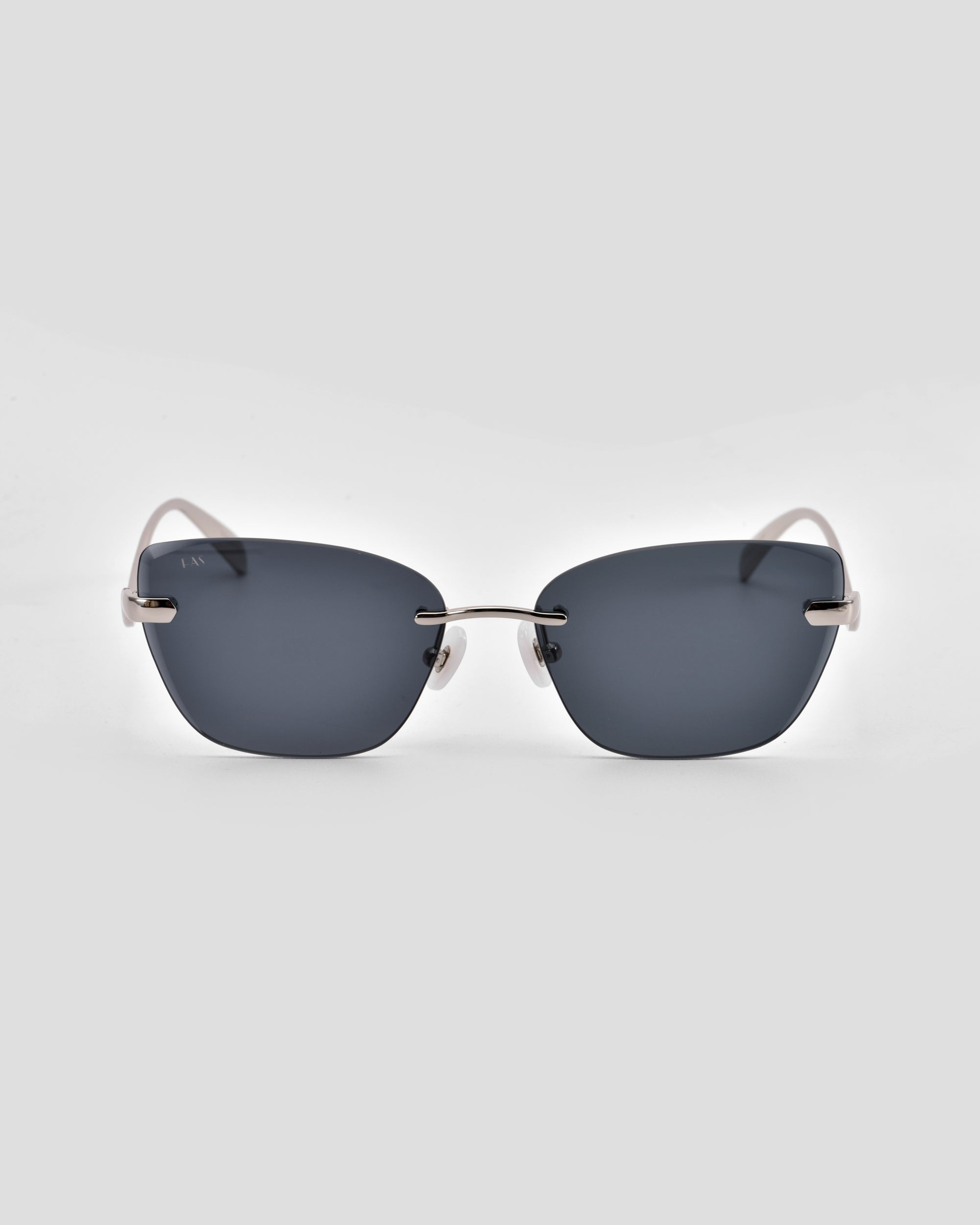 For Art’s Sake® Spark: futuristic rimless rectangular sunglasses featuring dark lenses and thin silver metal arms, shown against a plain light gray background.