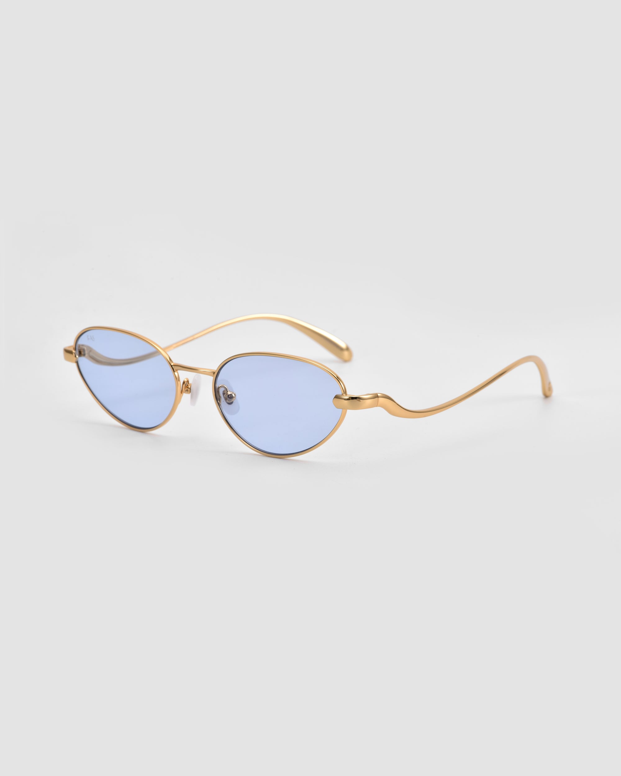 For Art's Sake® Rebirth sunglasses feature gold frames, oval light blue lenses, and wavy thin arms for a futuristic look, showcased on a plain light gray background.