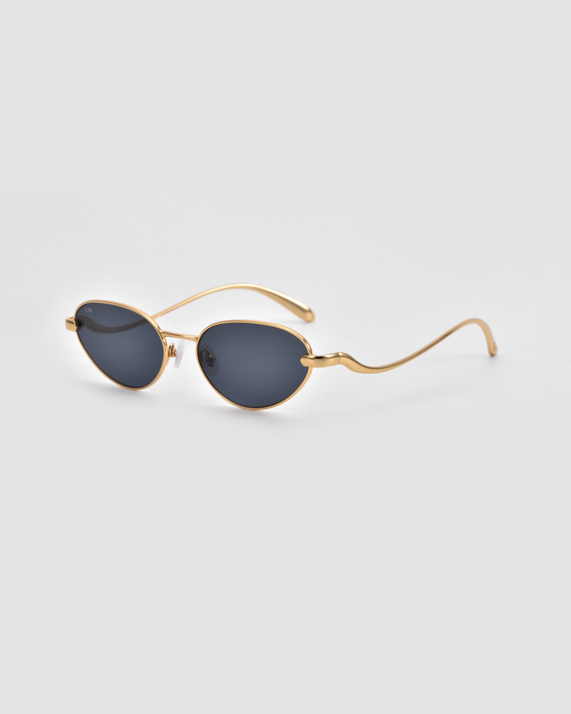 The For Art’s Sake® Rebirth sunglasses feature oval dark lenses and thin, gold 3D sculptural frames, elegantly displayed on a plain light gray background.