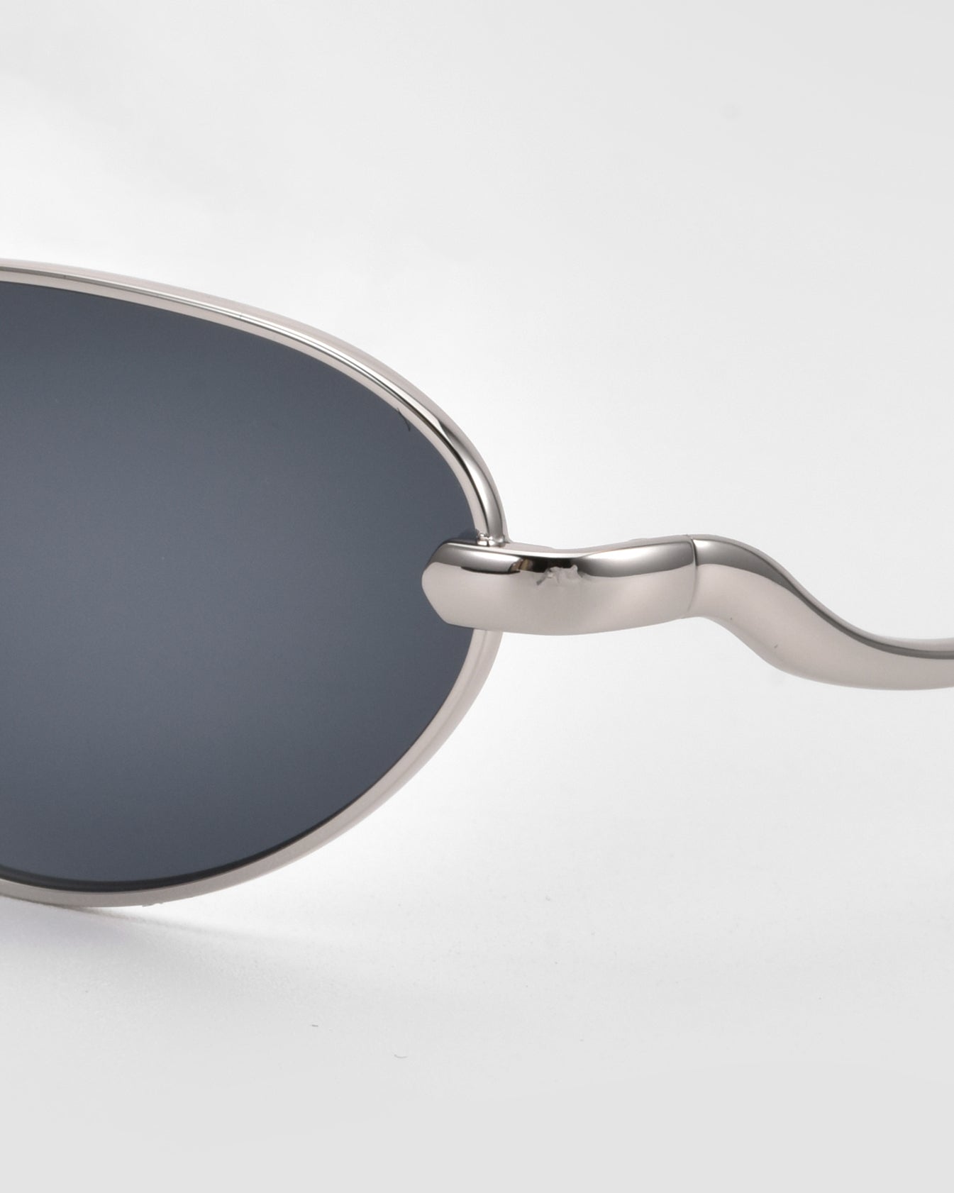 A close-up of Rebirth slim oval sunglasses by For Art&#39;s Sake®, highlighting their timeless eyewear design.