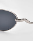 A close-up of Rebirth slim oval sunglasses by For Art's Sake®, highlighting their timeless eyewear design.