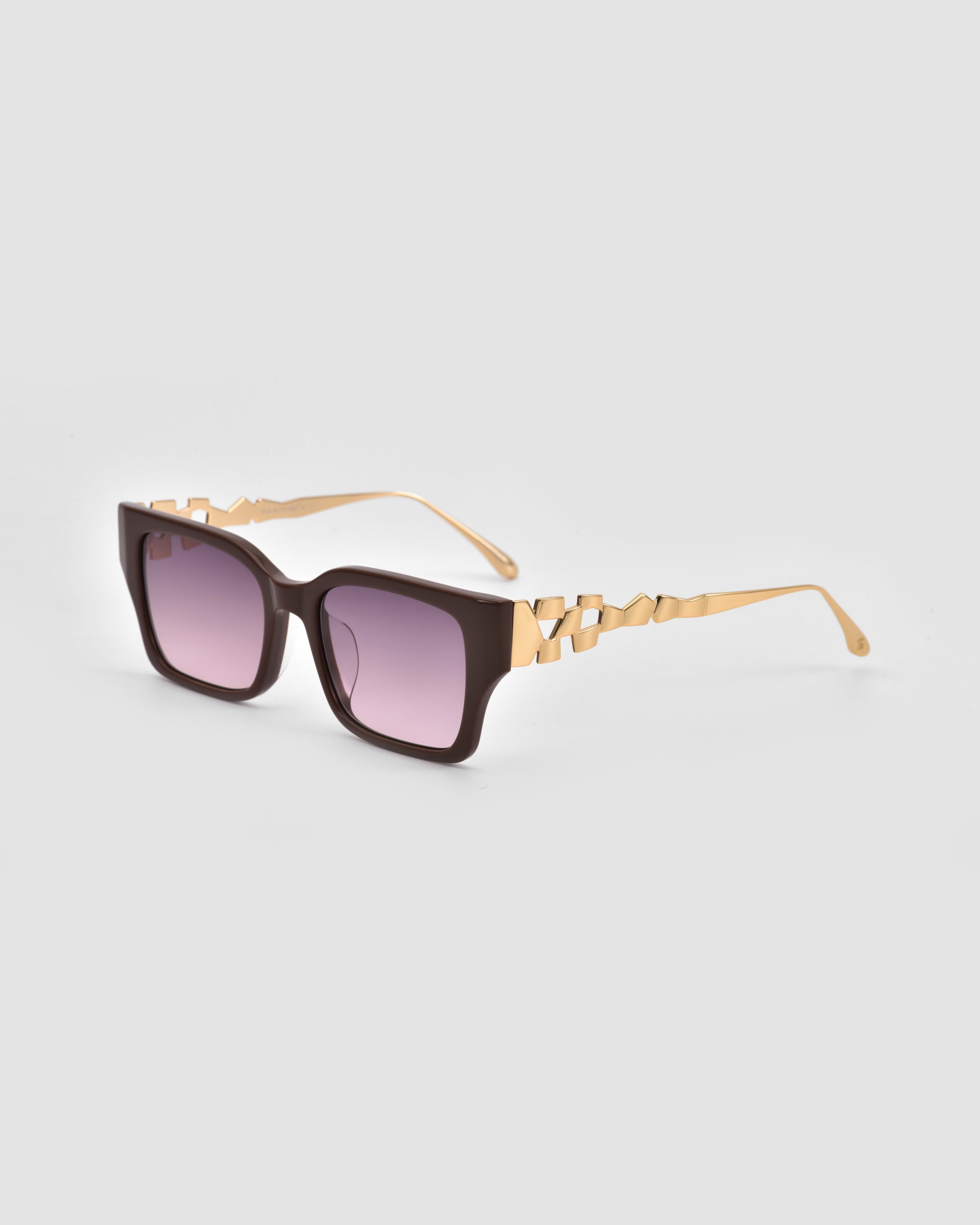 The For Art's Sake® Incomplete sunglasses feature large rectangular dark purple lenses, thick black frames, and gold arms with a detailed mosaic metal design, shown on a plain light gray background.