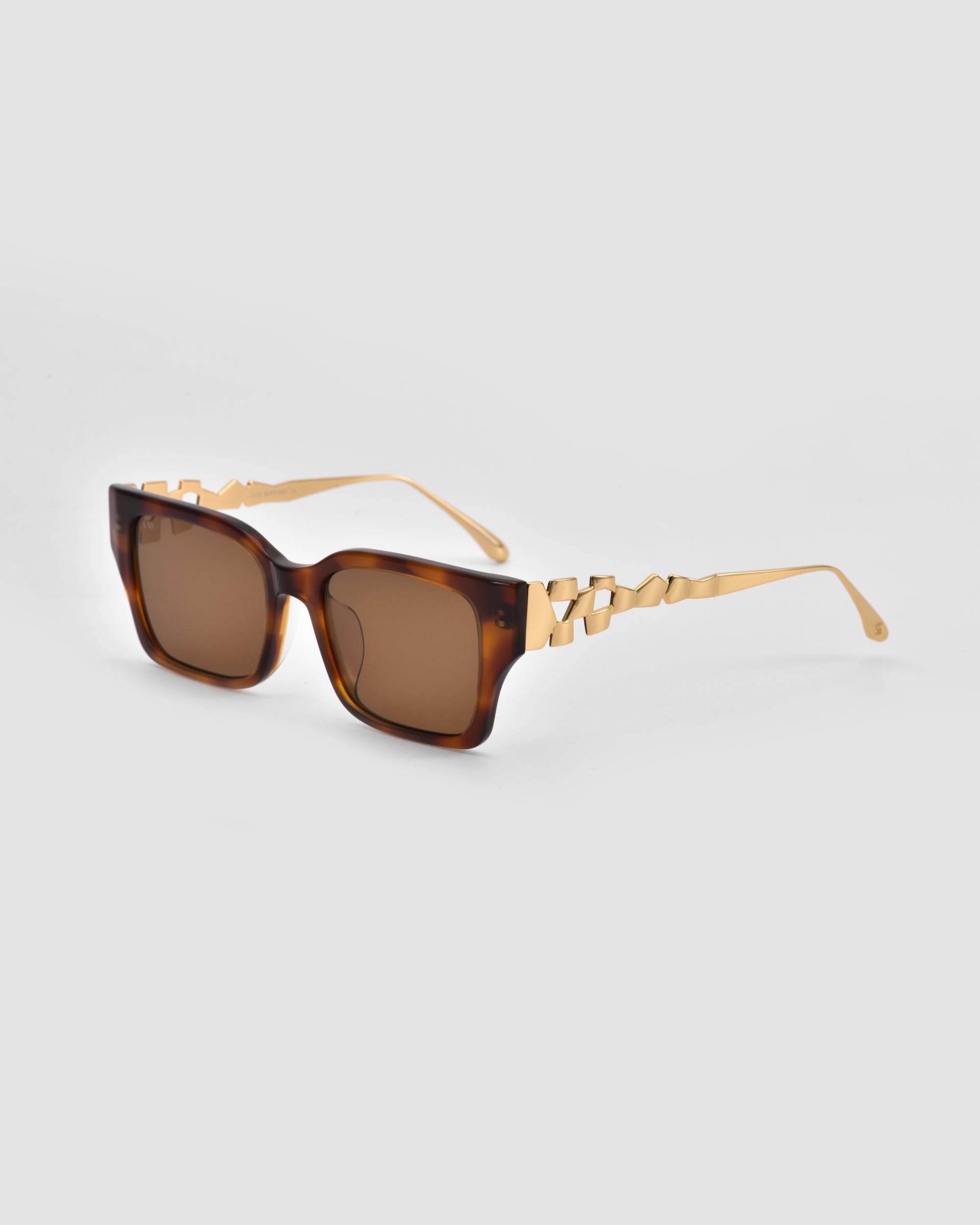 For Art's Sake® Incomplete sunglasses in brown tortoiseshell square acetate with gold mosaic metal arms, shown on a light gray background.