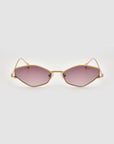 The For Art's Sake® Moment sunglasses feature a gold geometric metal frame and slightly hexagonal pink-tinted lenses, shown against a light gray background.