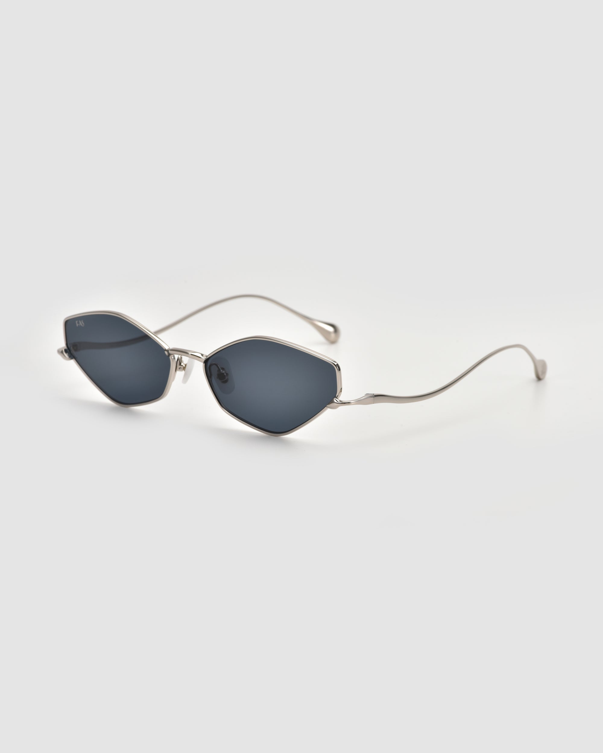 The For Art's Sake® Moment sunglasses feature a sleek silver metal frame with dark oval lenses and thin, curved arms, shown on a plain light grey background.